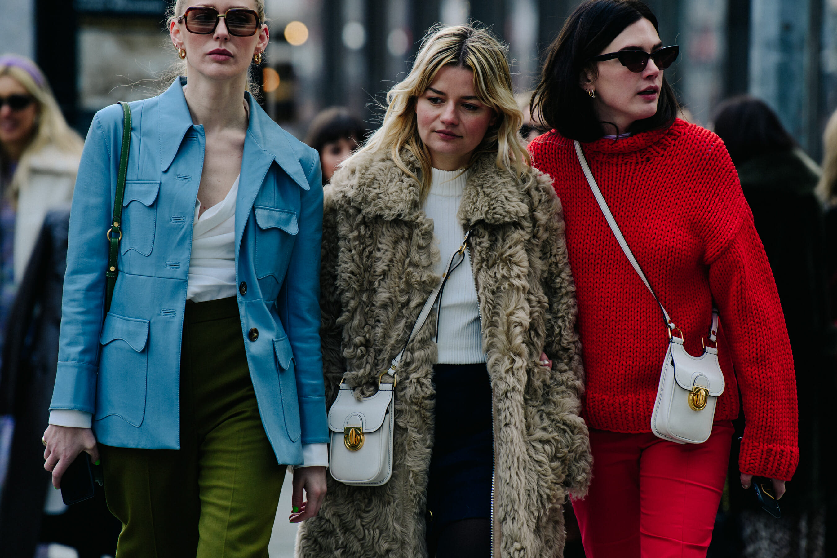Three bloggers wearing white bags