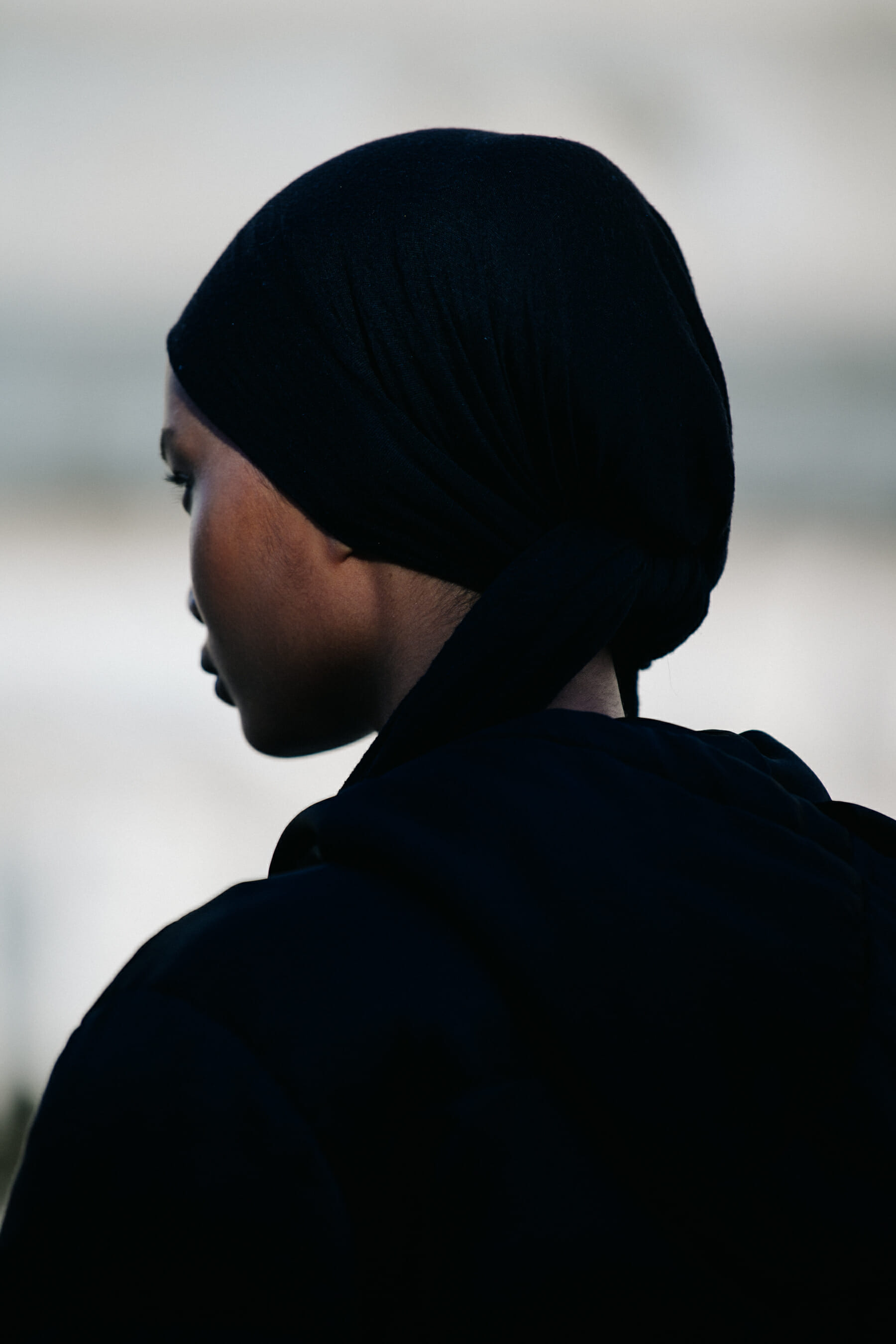 Model wearing black headscarf