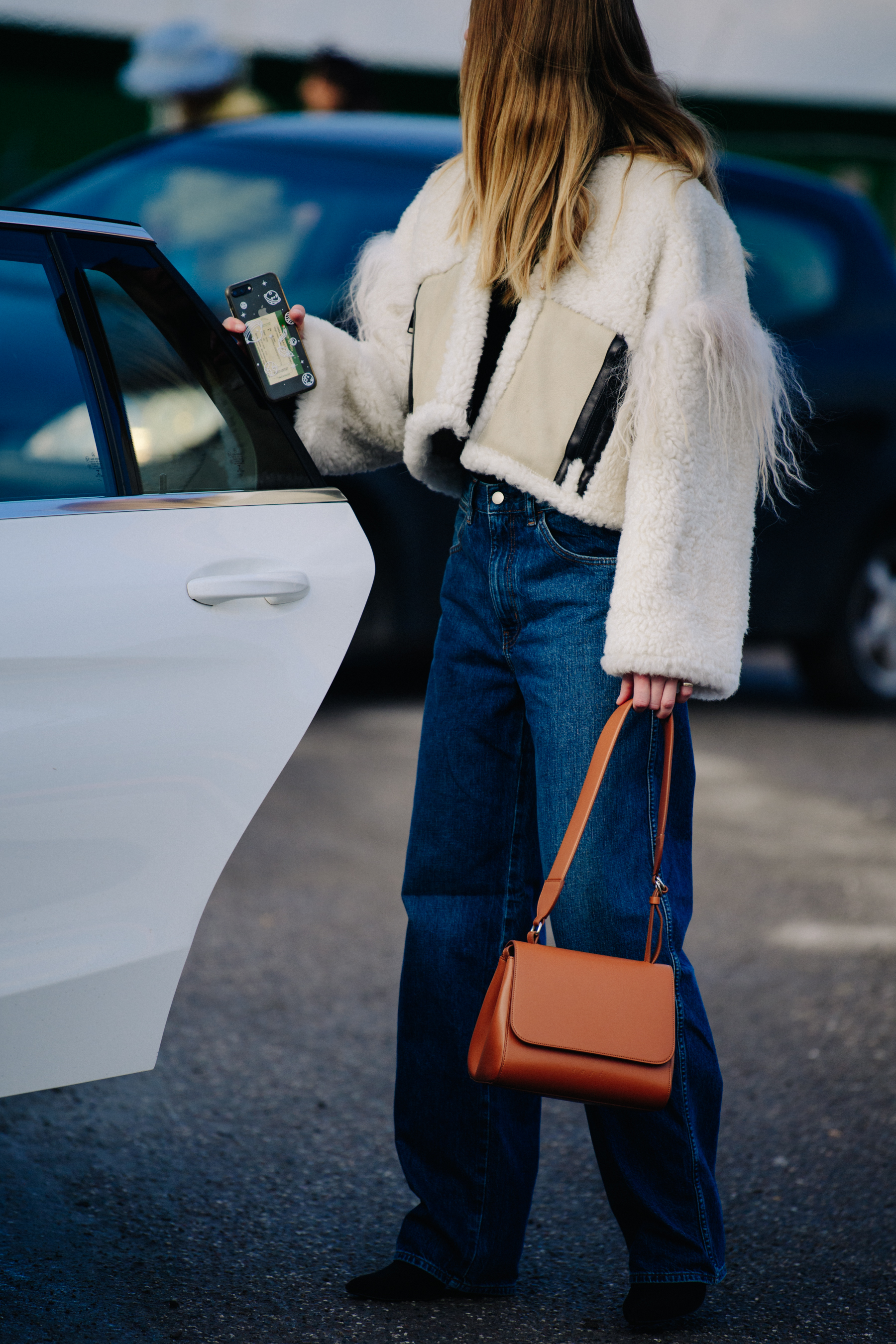 Woman wearing white fur jacket