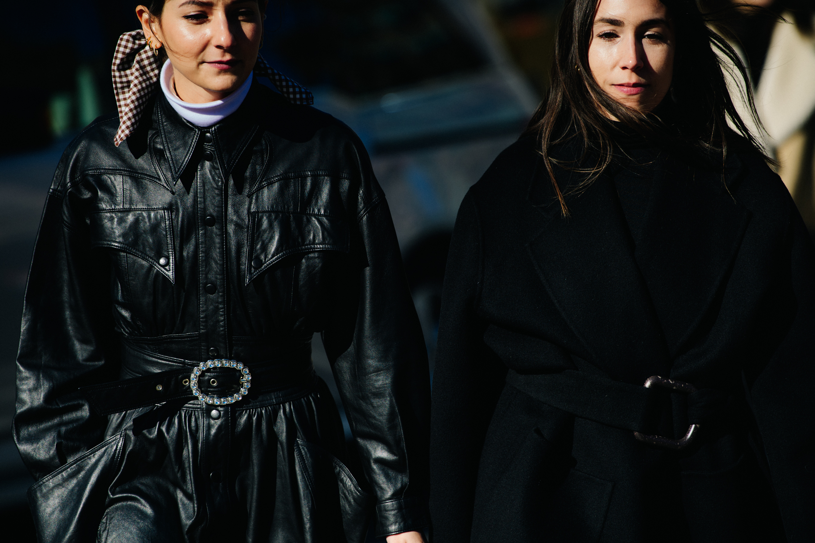 Two women wearing black coats