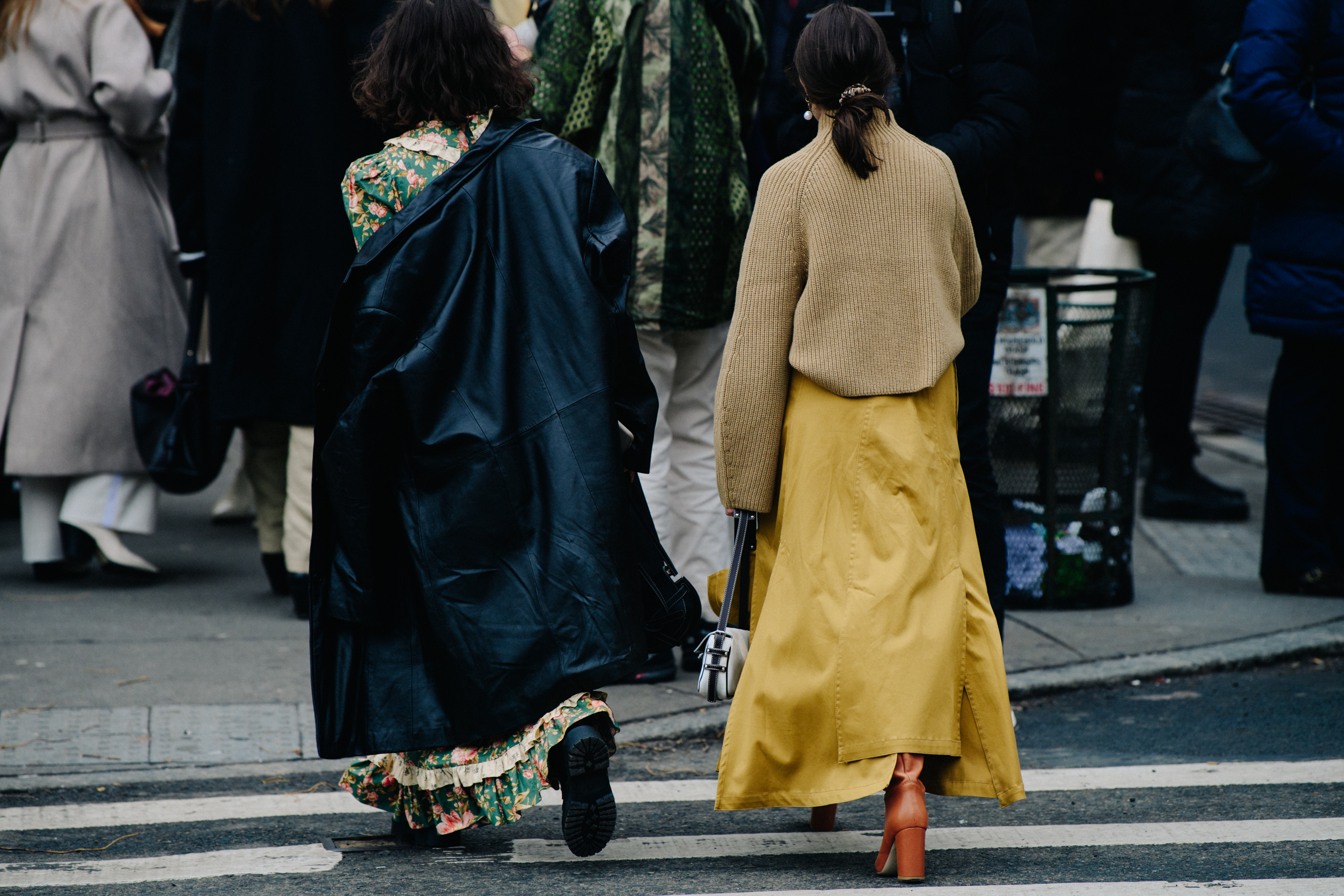 Two women wearing long dresses
