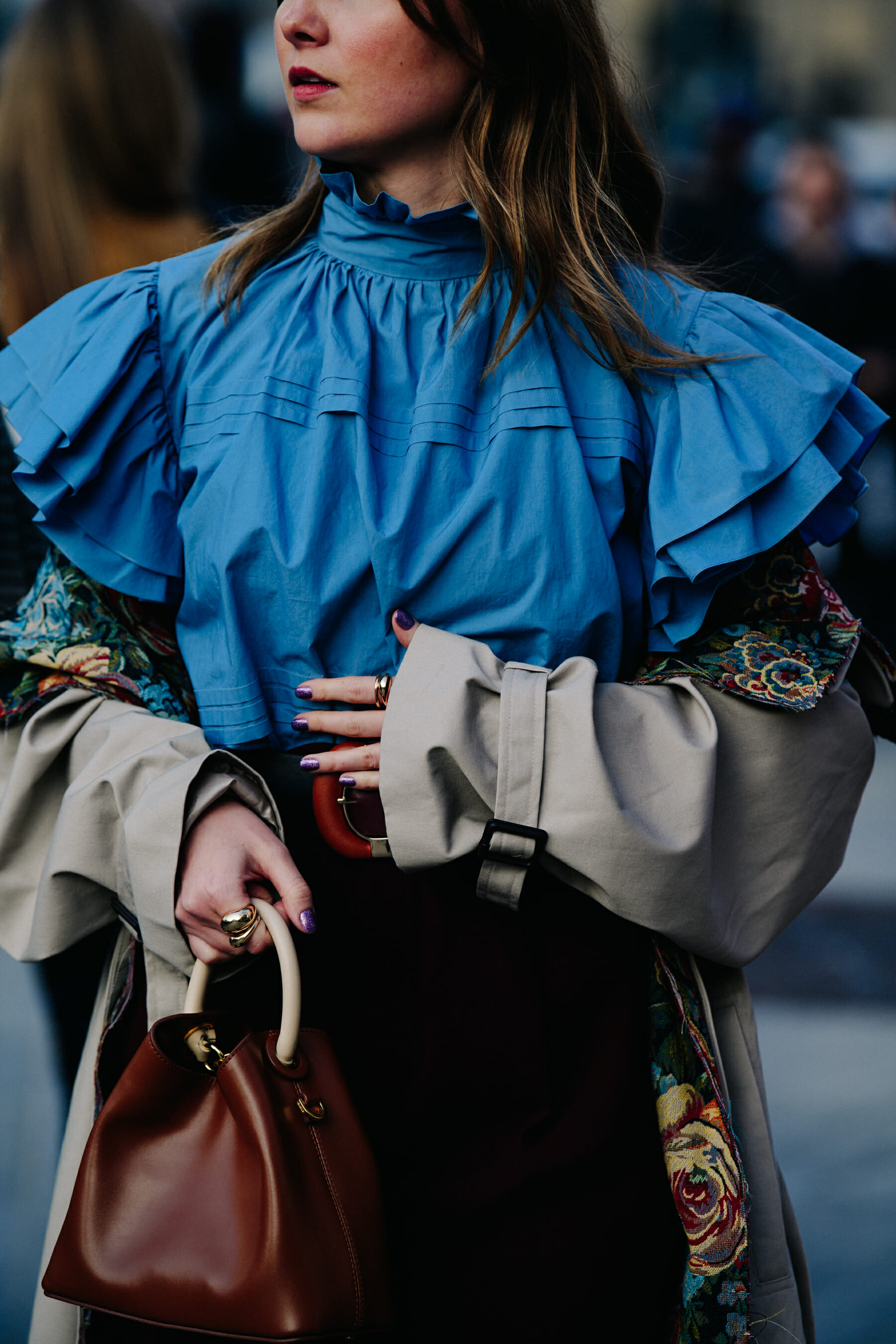 Woman wearing frilled blue top