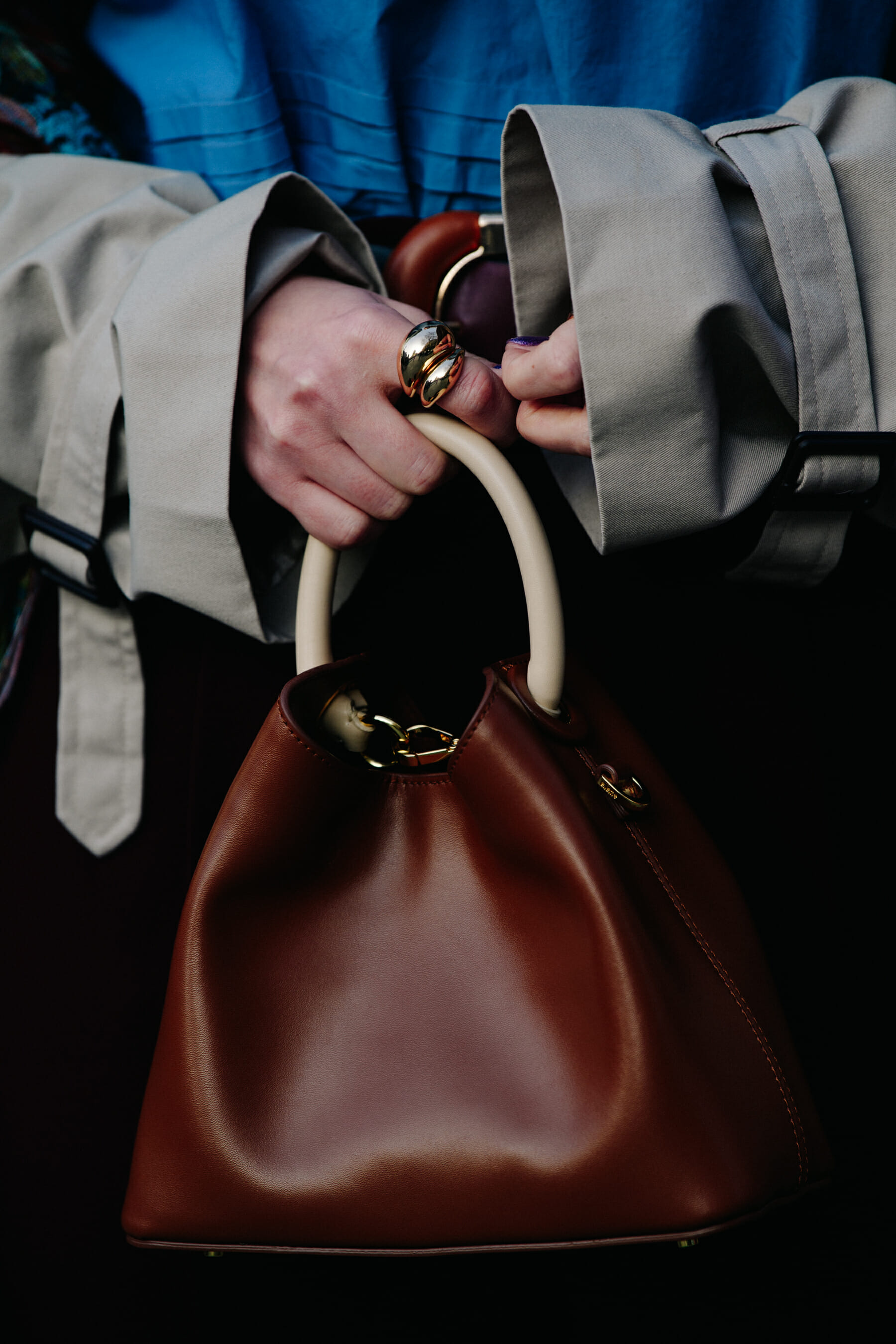 Woman carrying brown leather bag