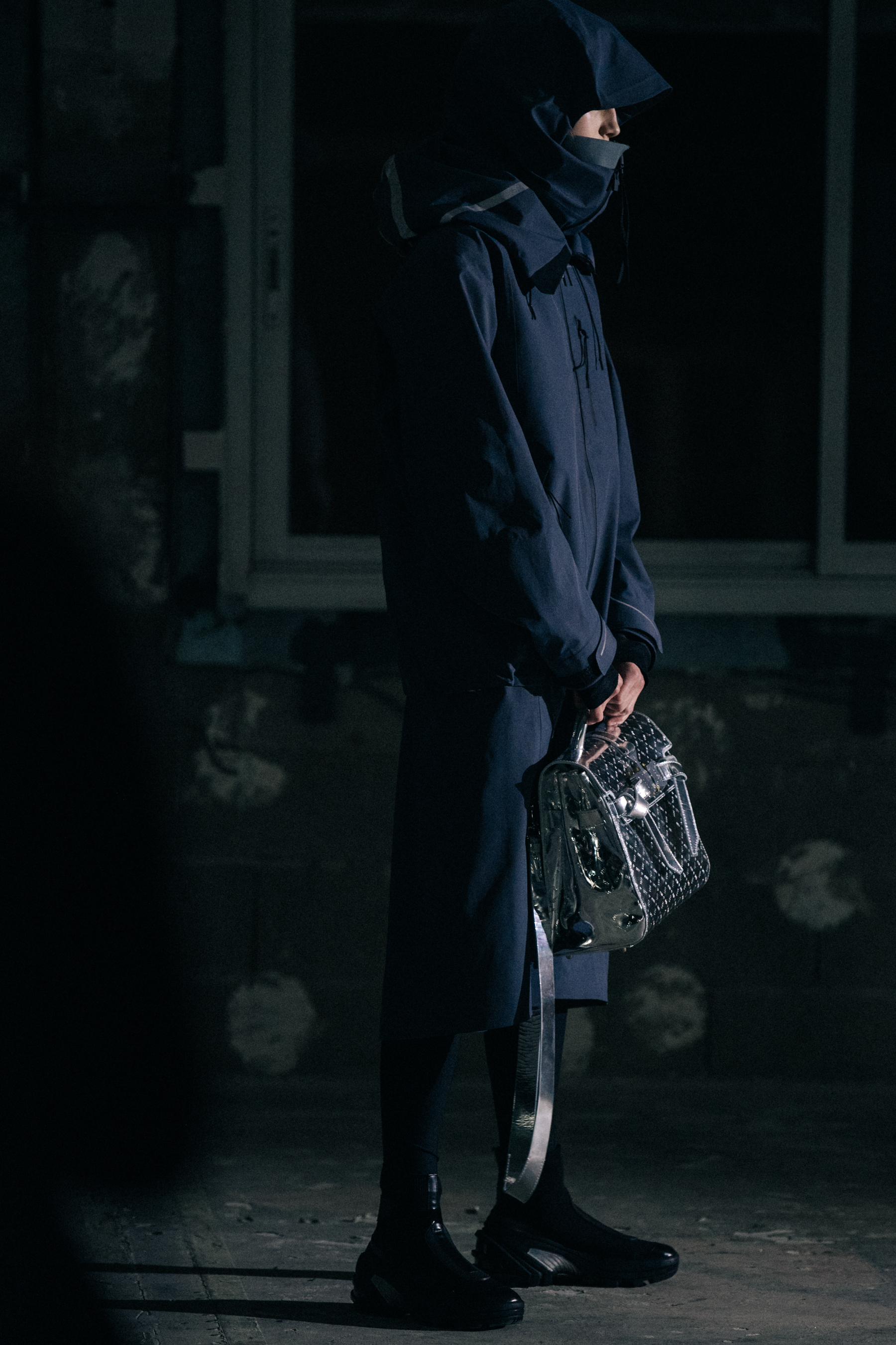 Model wearing dark outfit backstage at 1017 ALYX 9SM