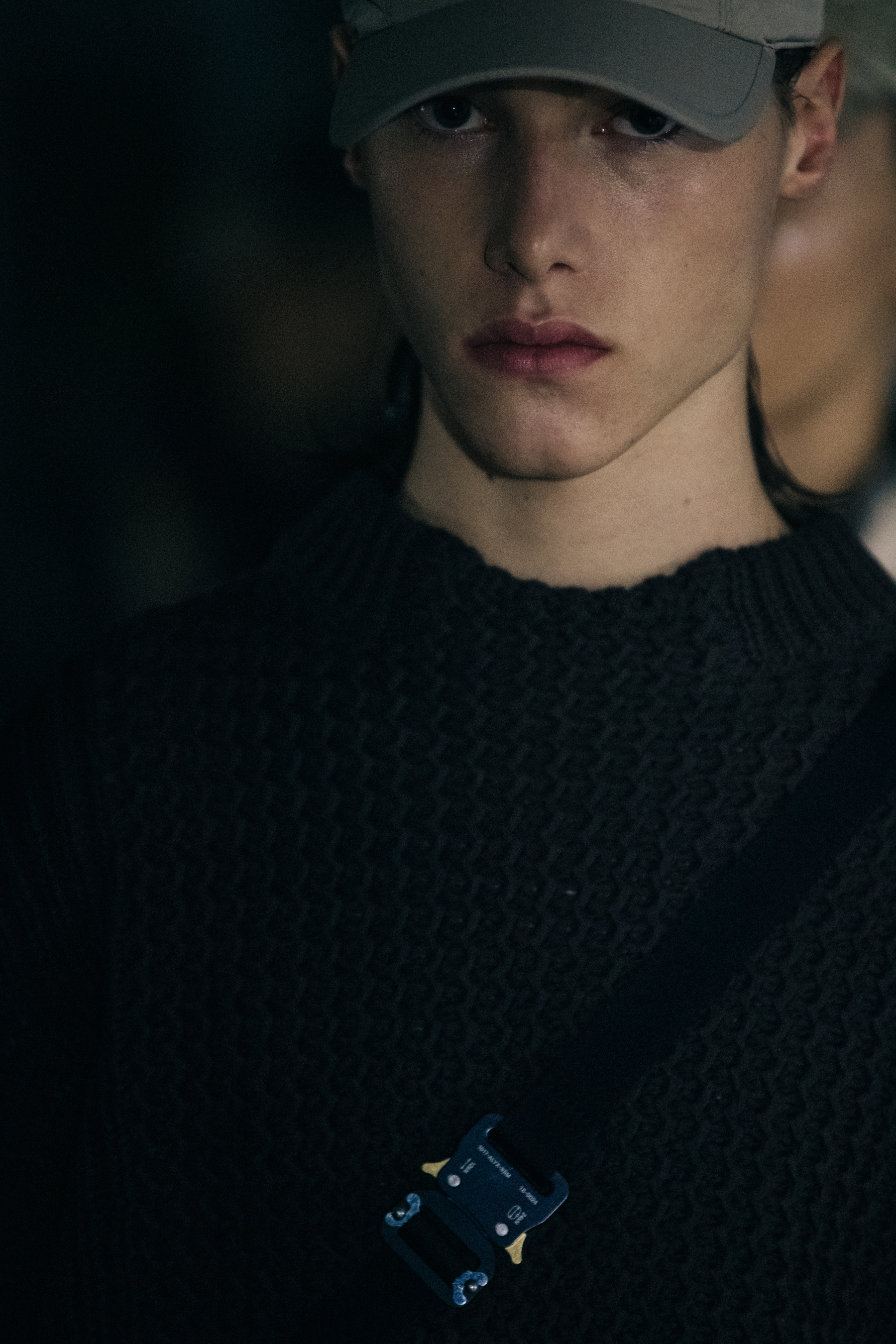 Model wearing cap backstage at 1017 ALYX 9SM