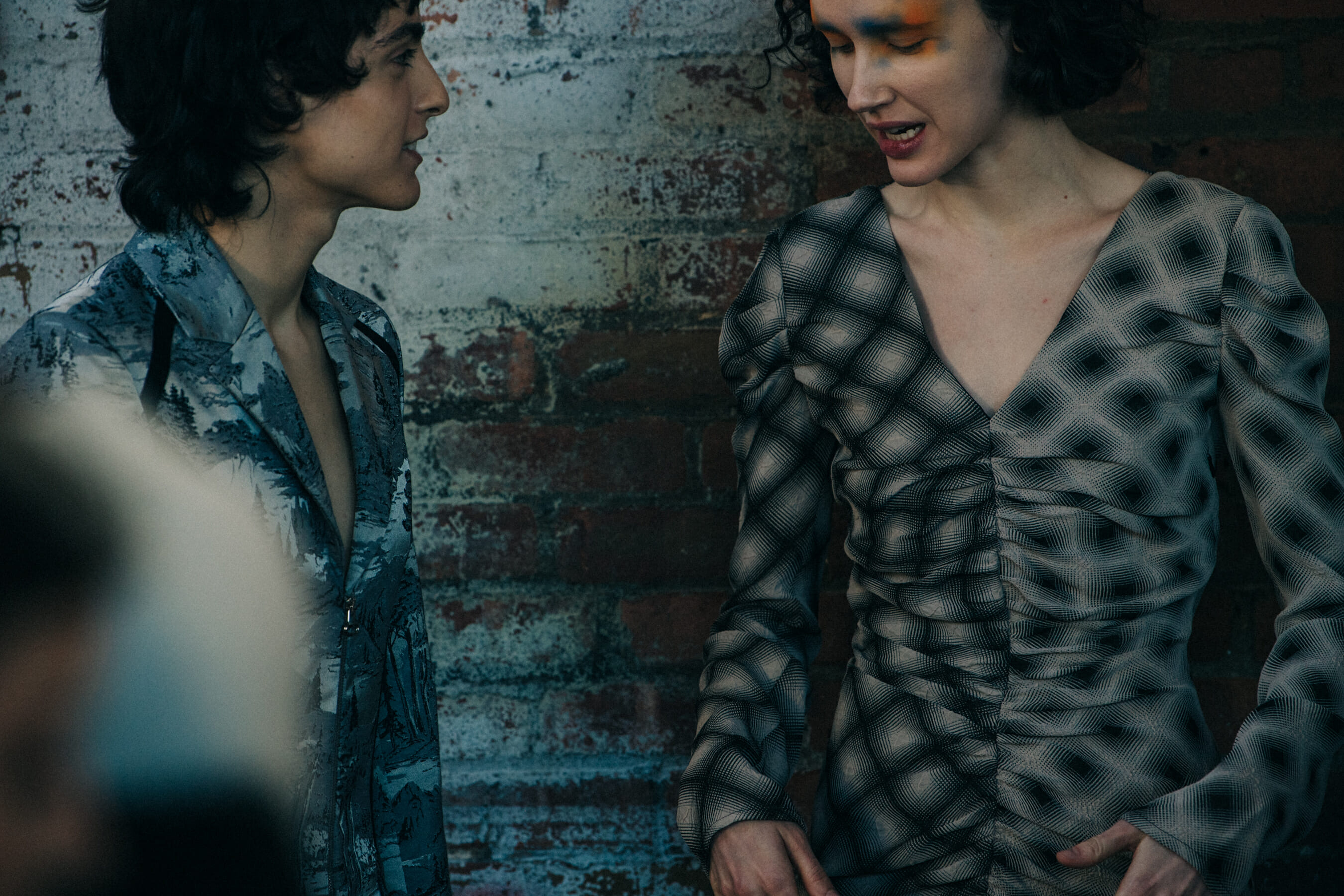 Model backstage wearing colourful makeup