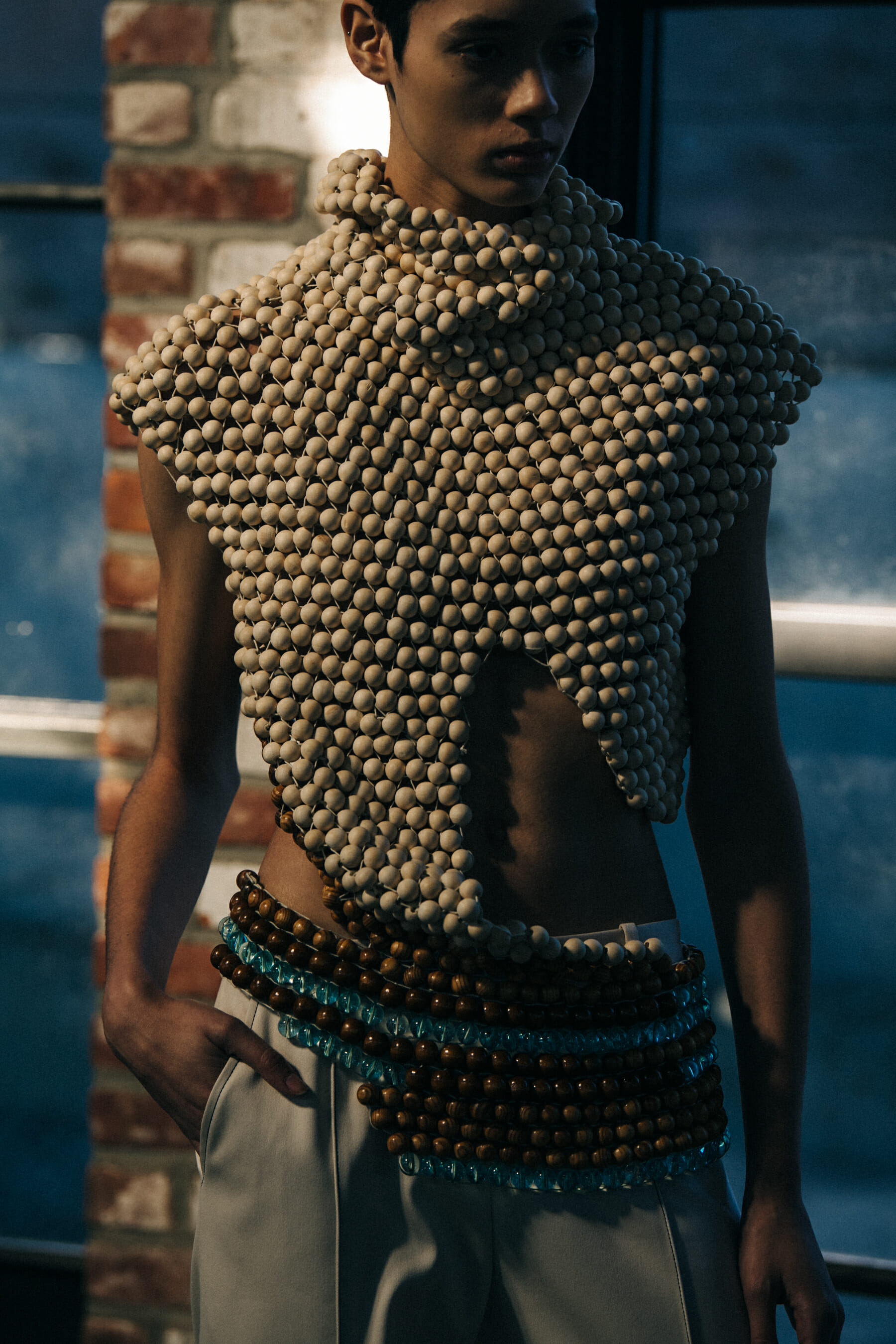 Model wearing wooden bead outfit