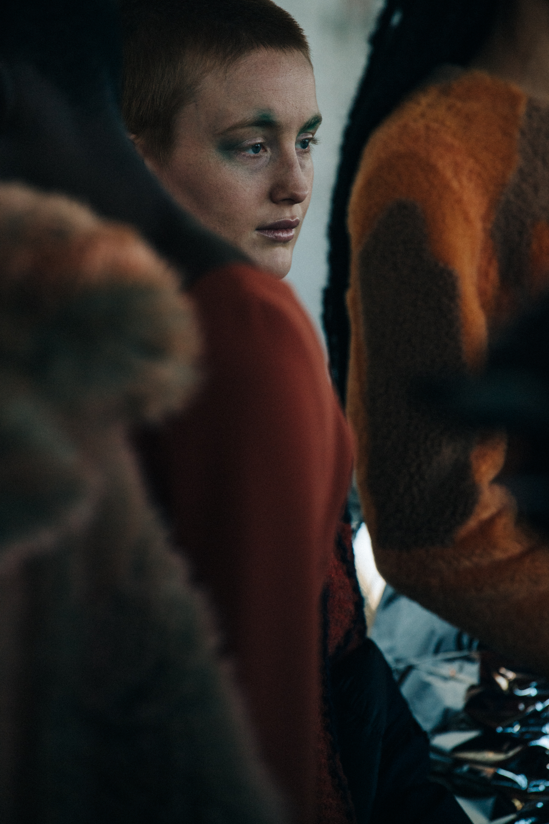 Model backstage wearing colourful makeup