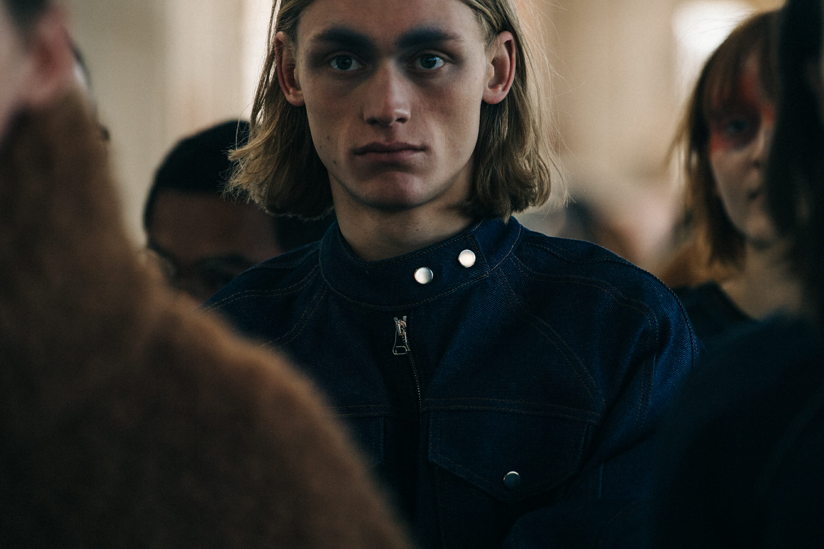 Model backstage wearing colourful makeup