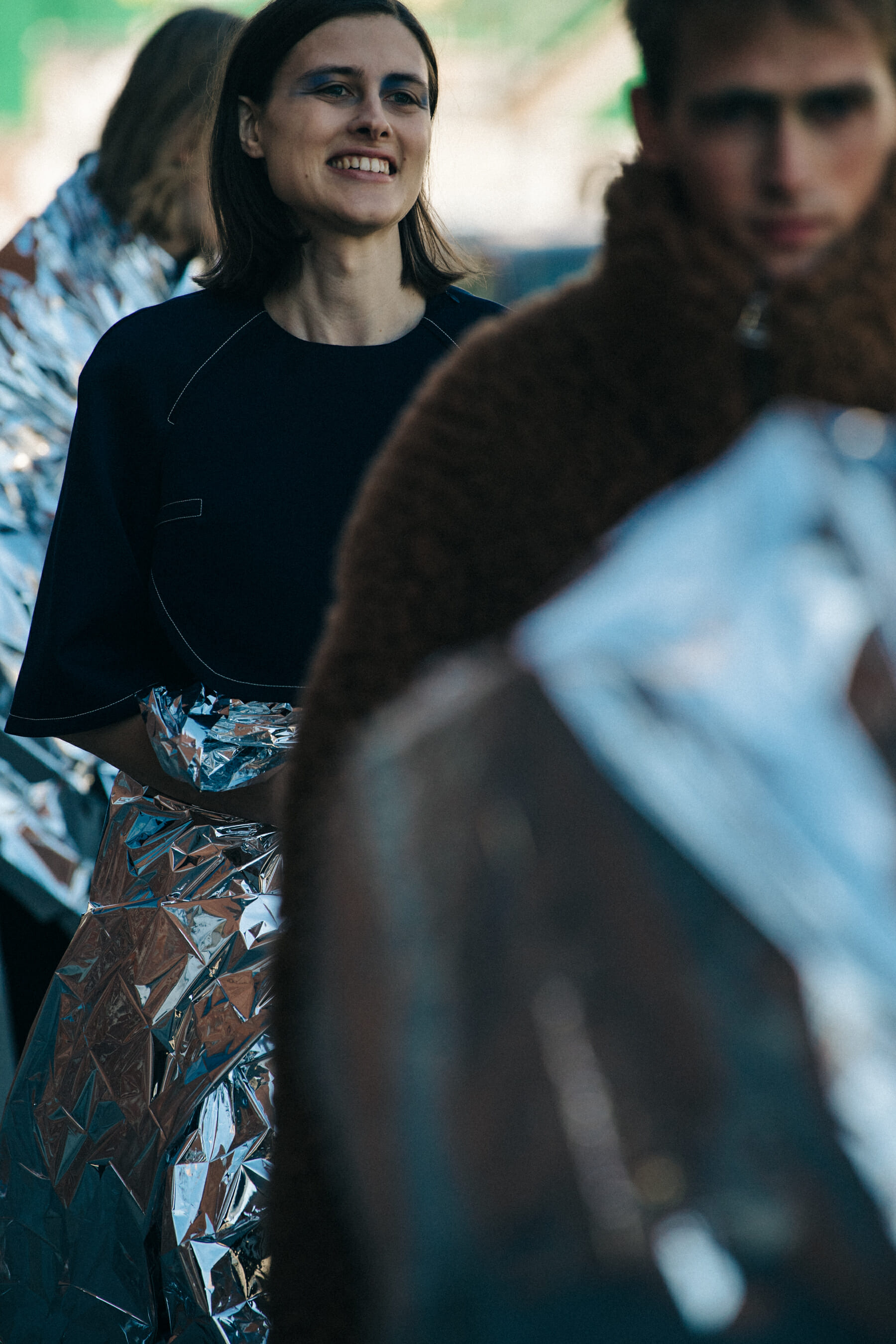 Model backstage wearing colourful makeup