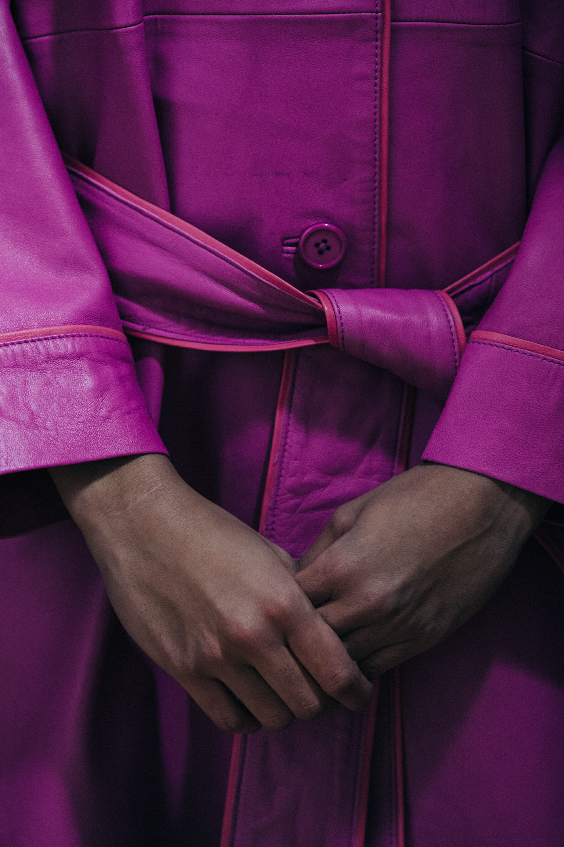 Model wearing purple backstage at STAND