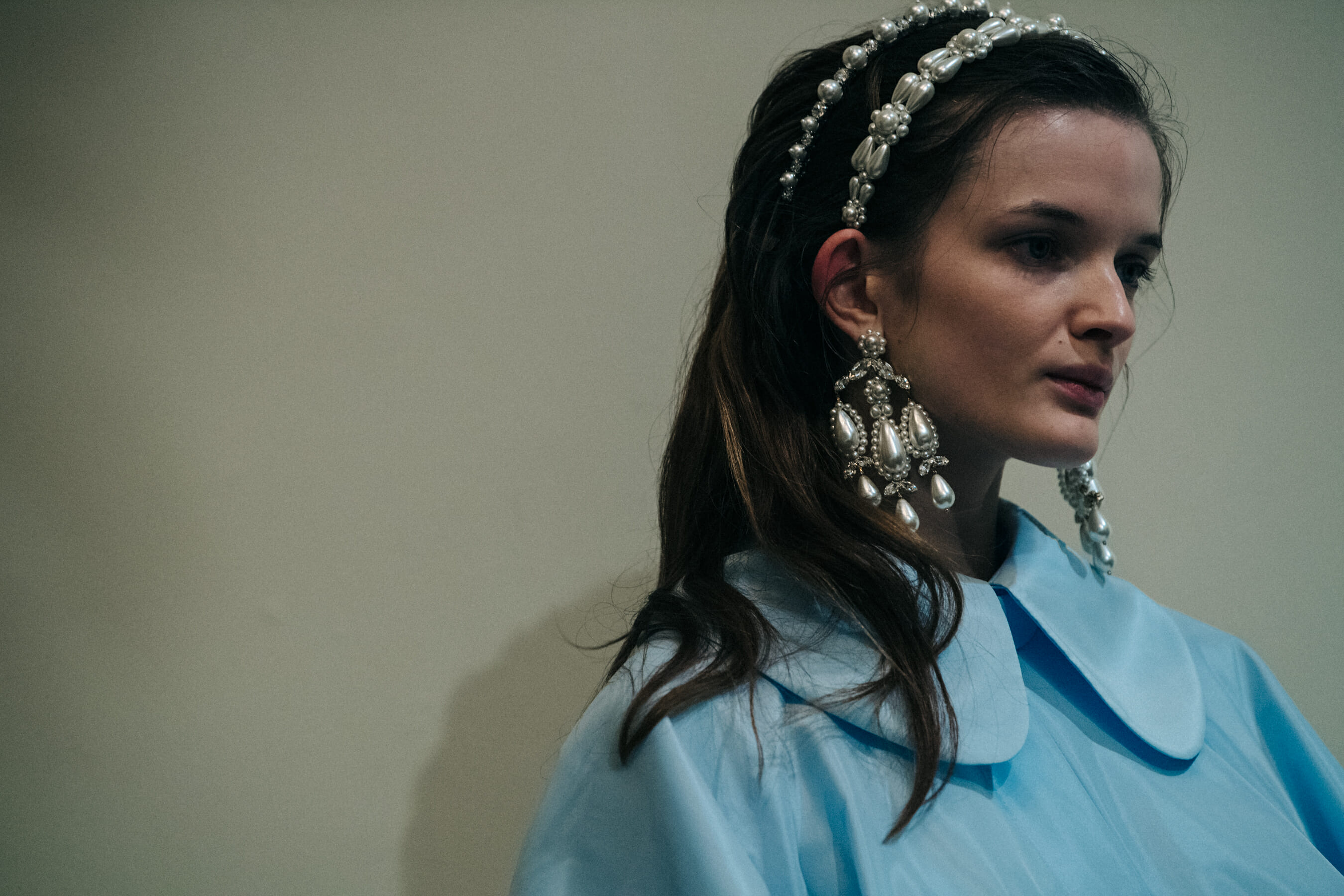 Model wearing blue dress backstage at Simone Rocha