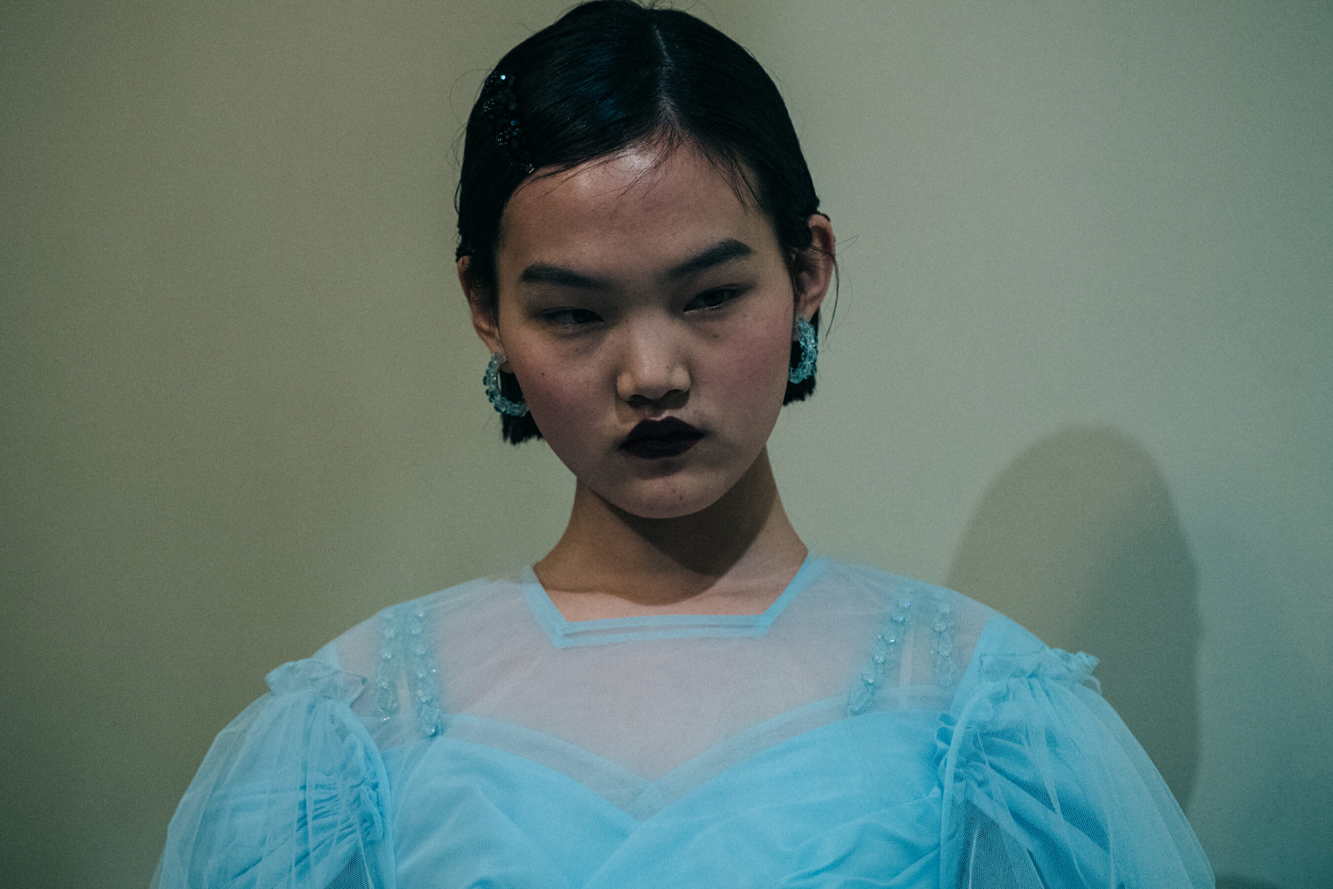 Model wearing blue dress backstage at Simone Rocha