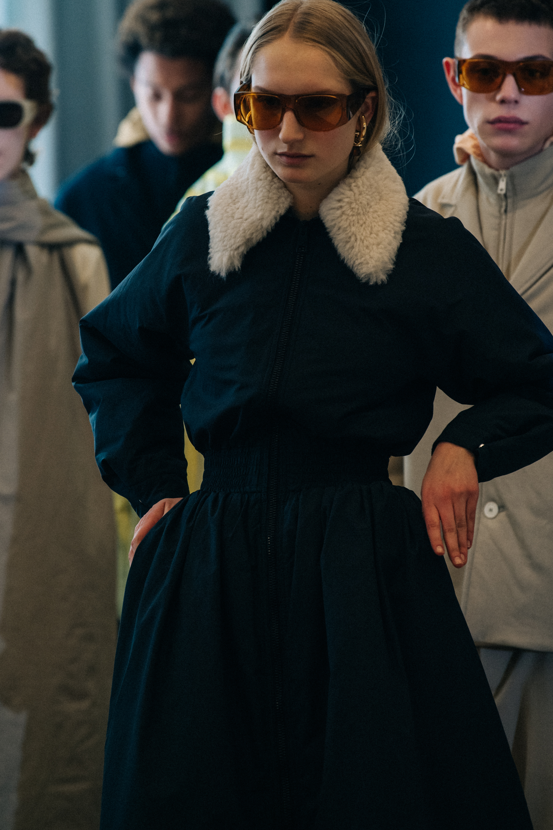 Model wearing fur backstage at Sunnei