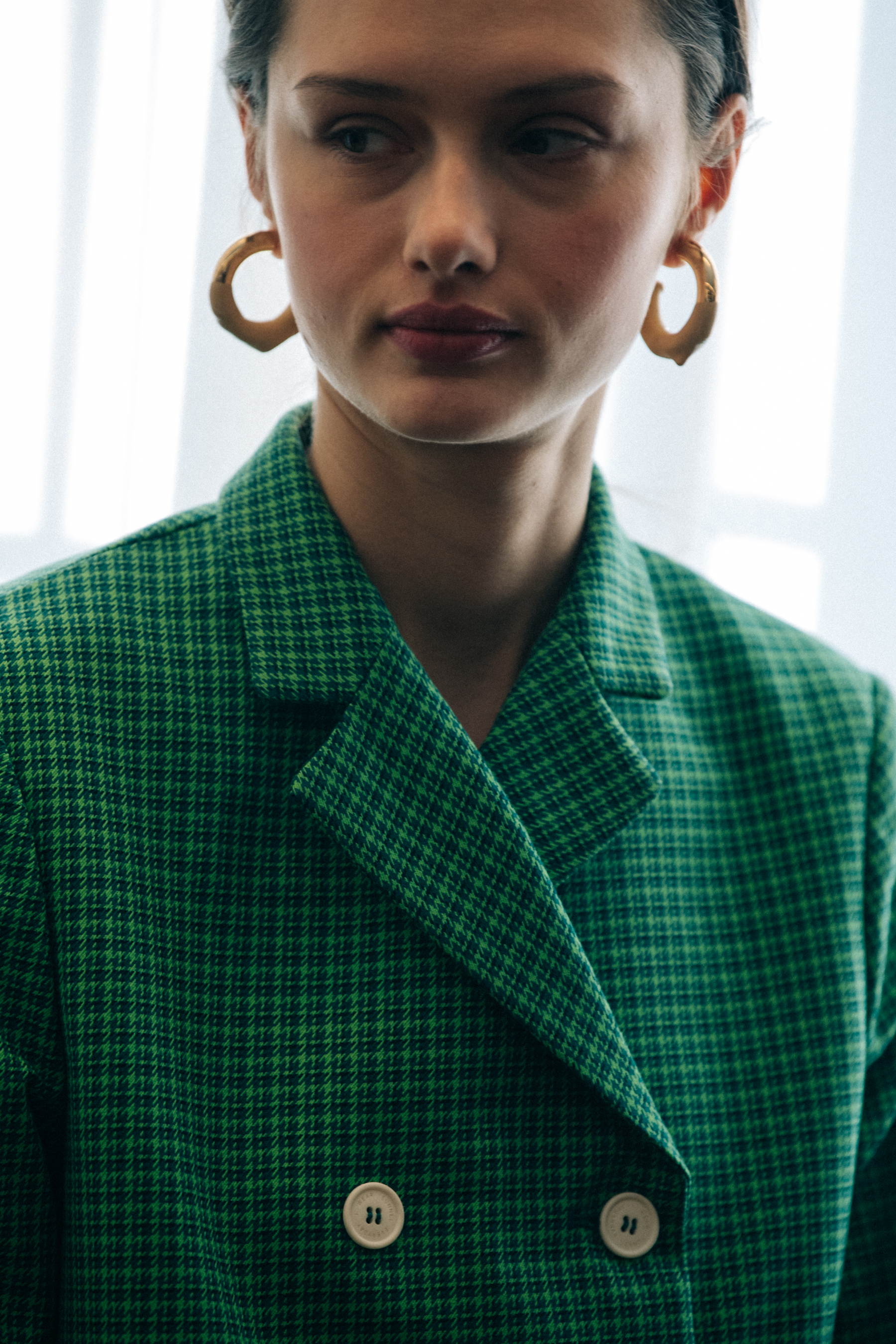 Model wearing coloured suit backstage