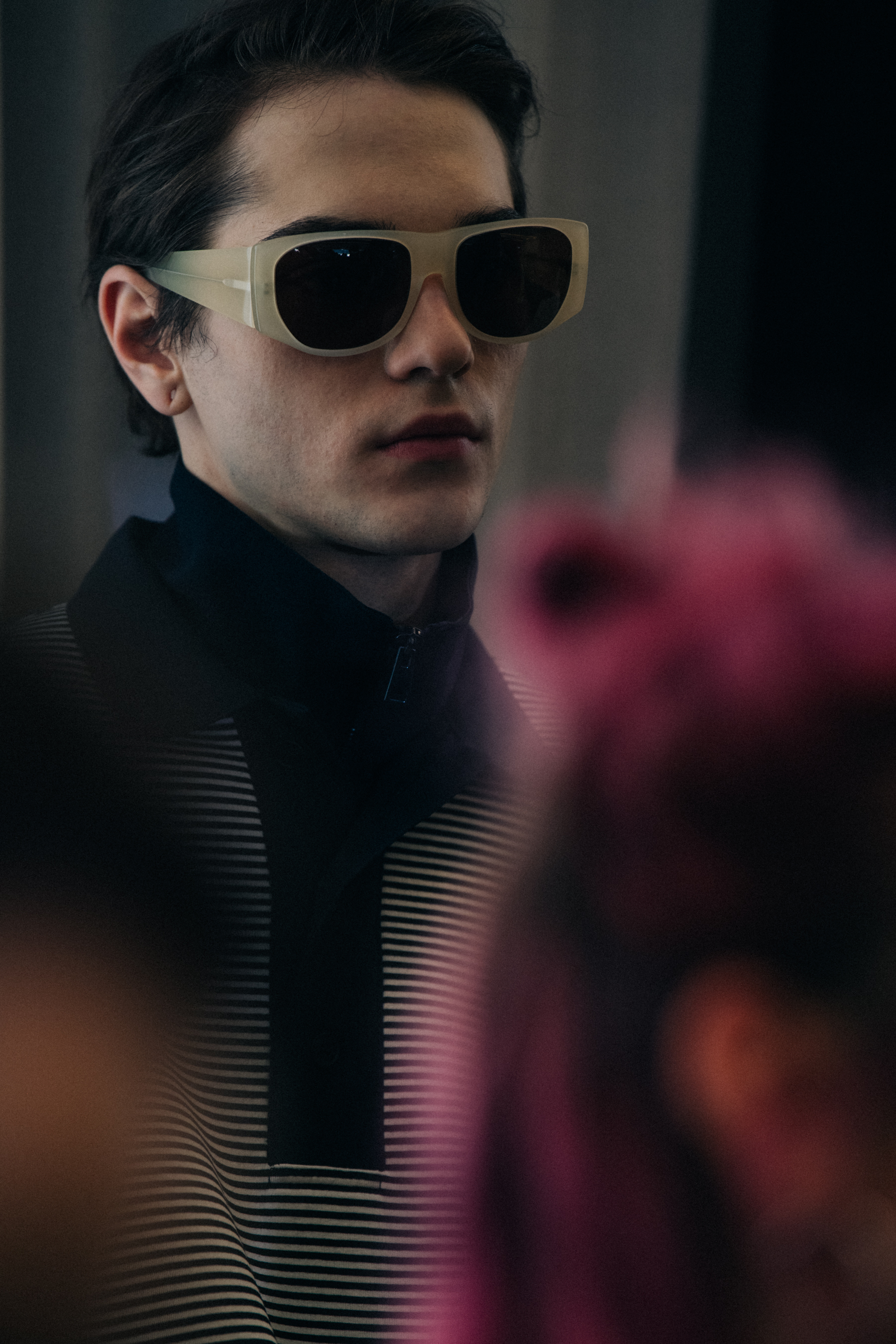 Model wearing high collar backstage at Sunnei