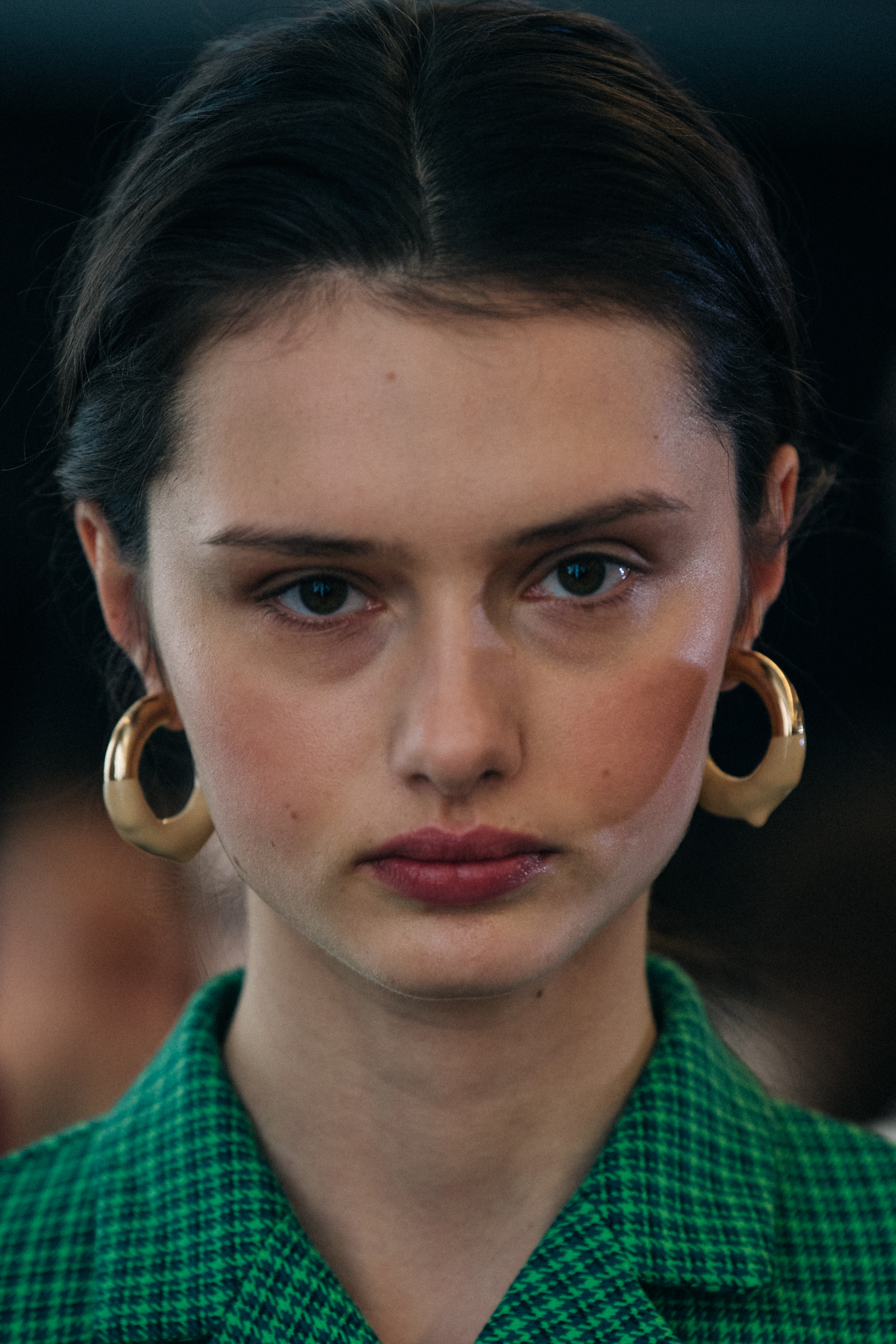 Portrait of model wearing gold earrings