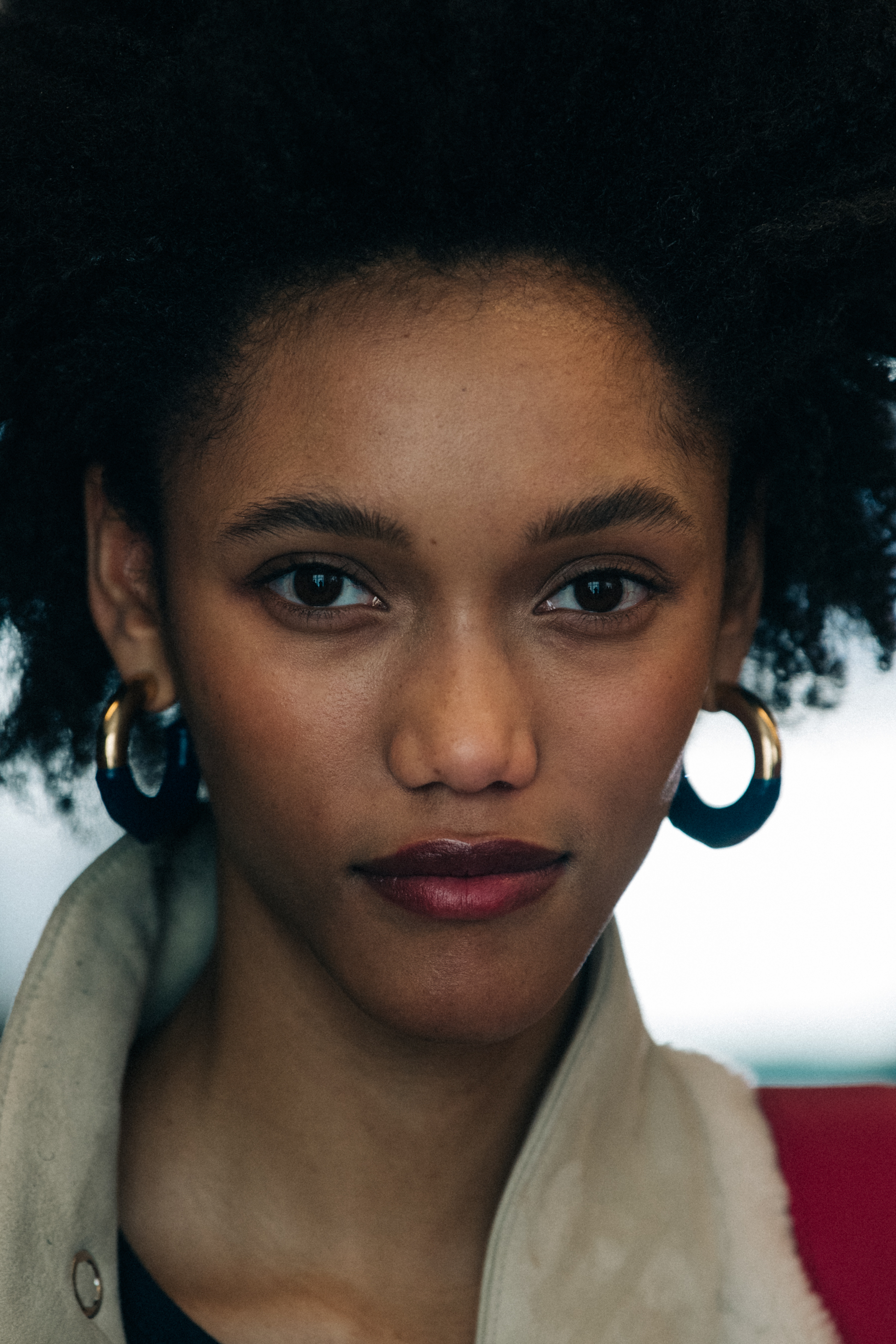 Portrait of model wearing gold earrings