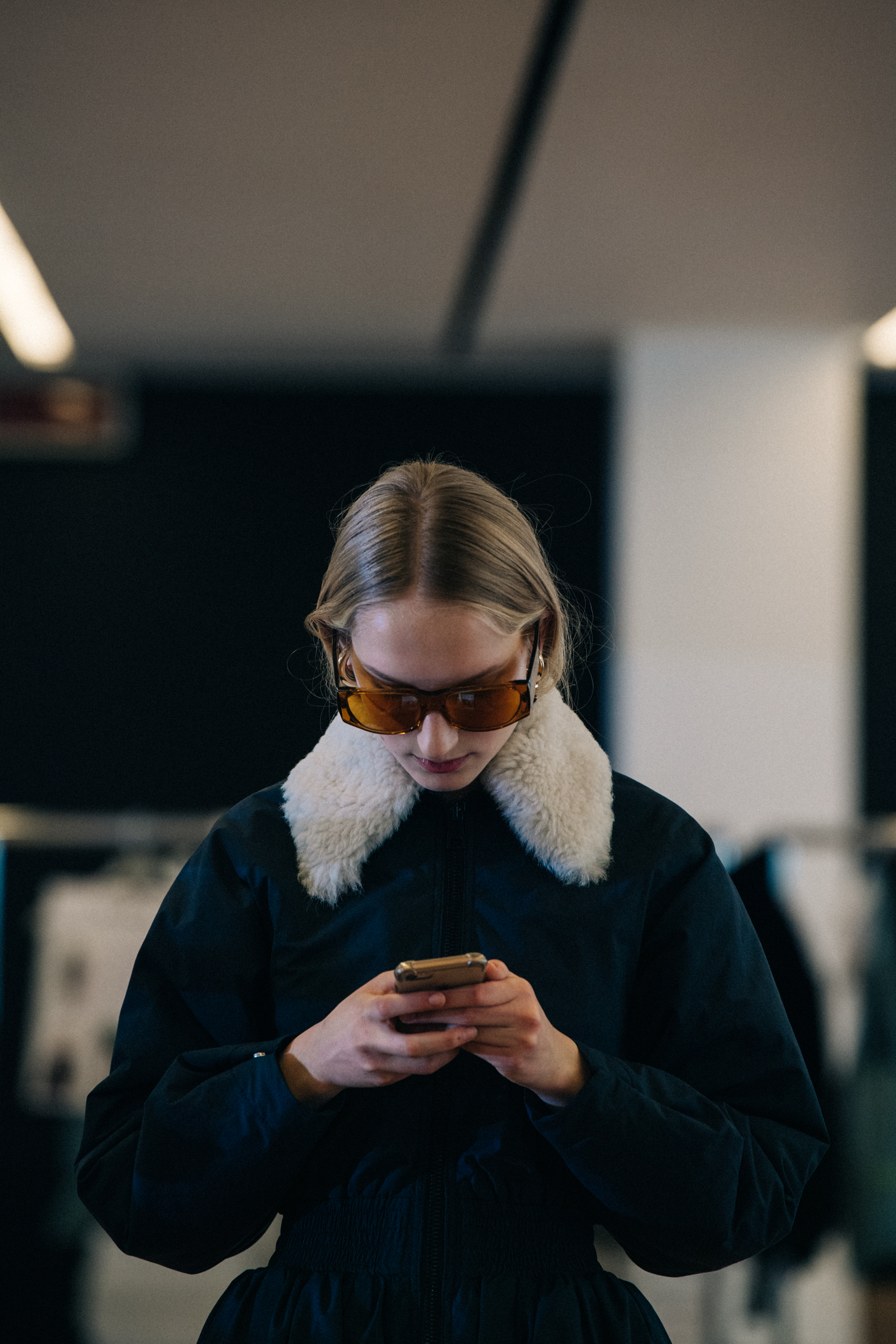 Model wearing fur backstage at Sunnei