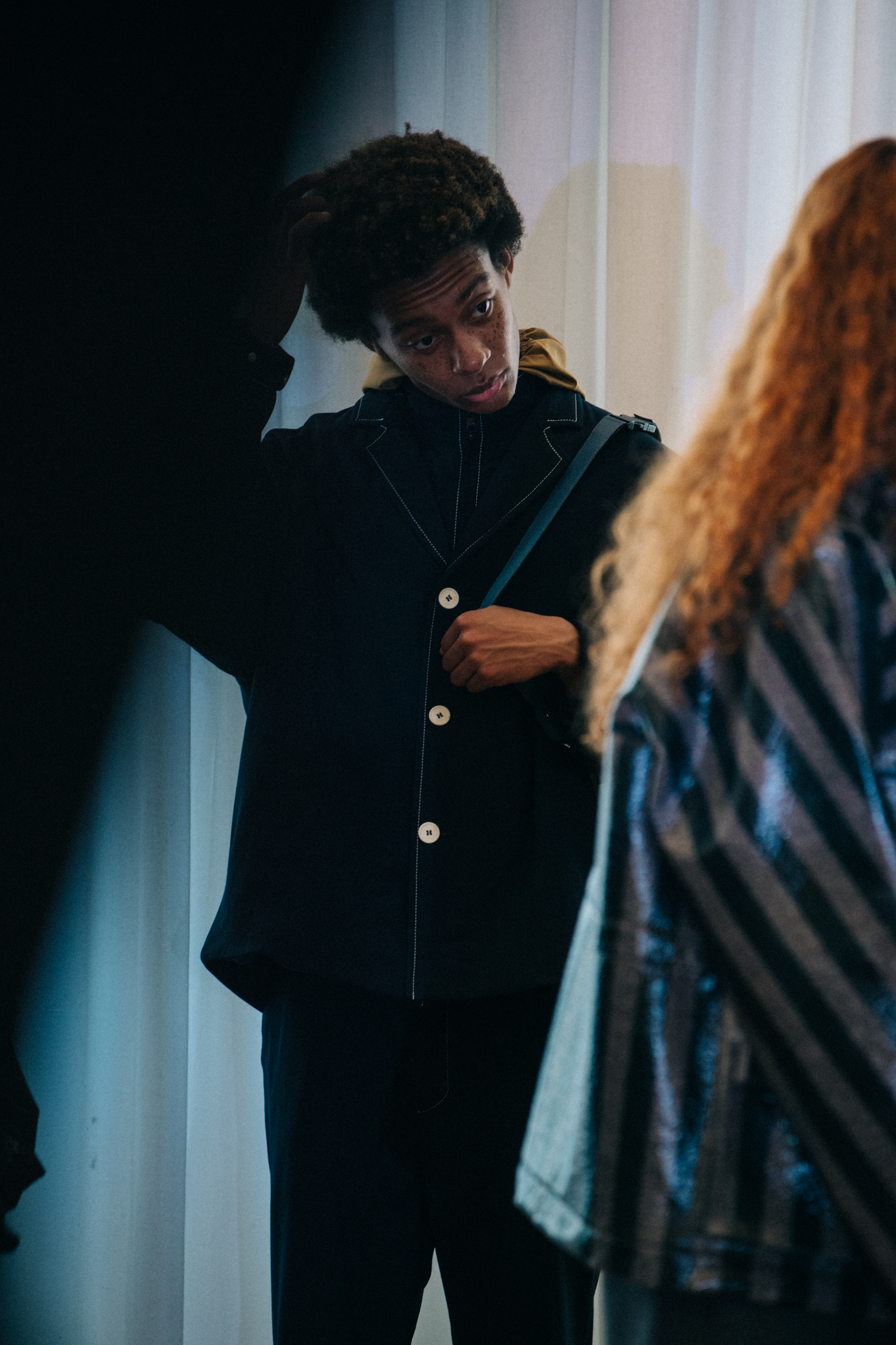 Model wearing stripes backstage