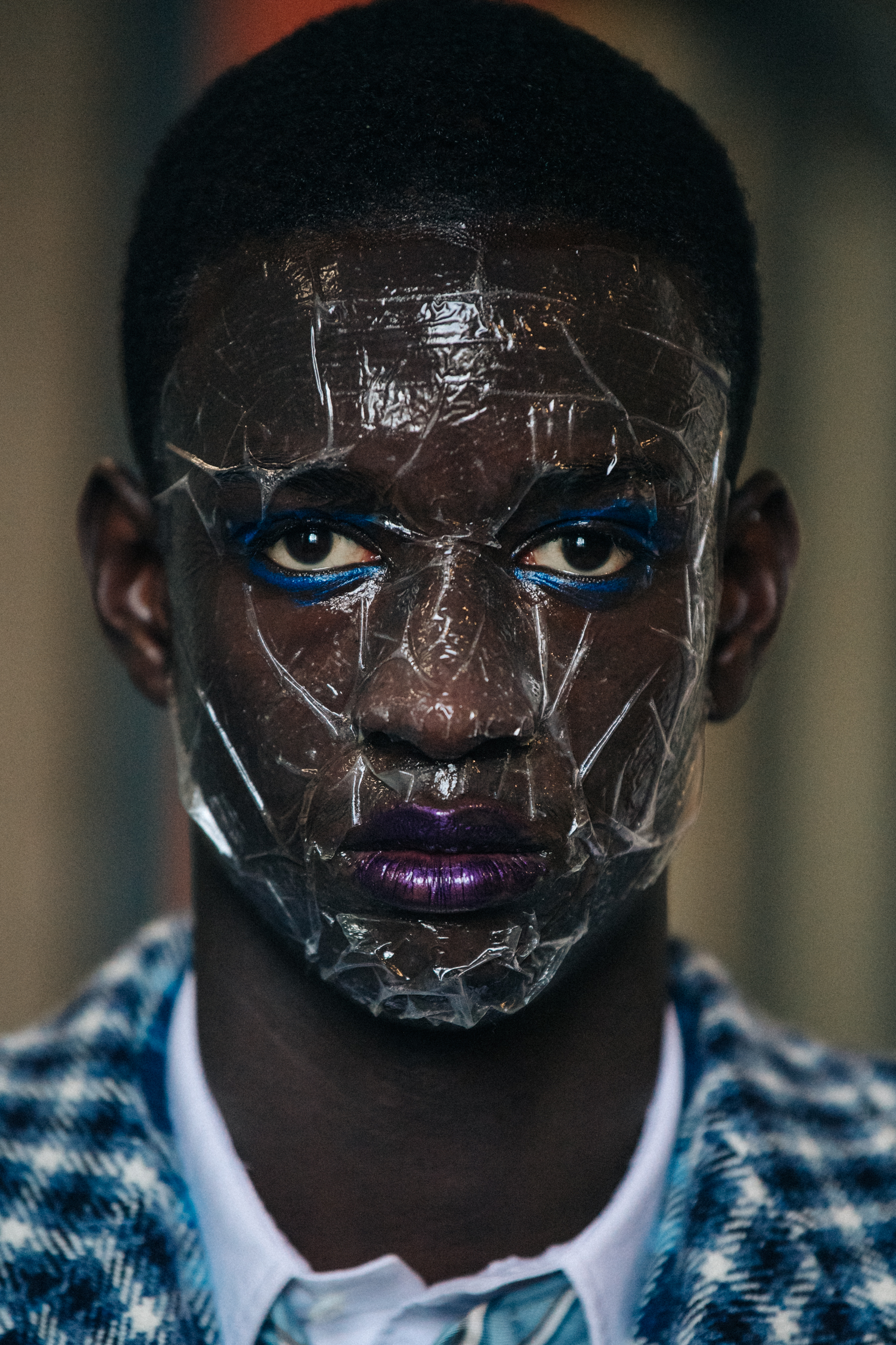 Portrait of model with sticky tape on face