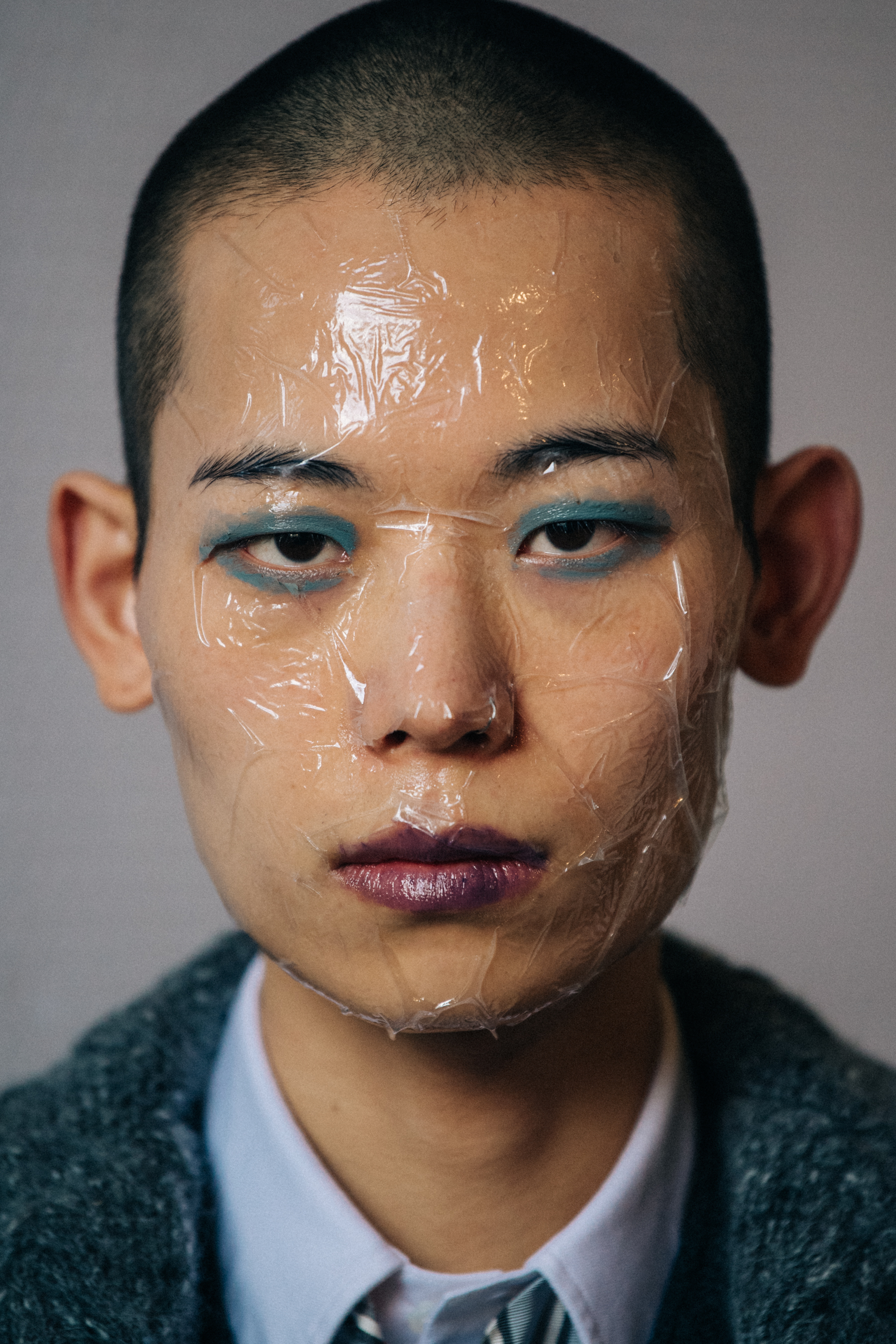 Portrait of model with sticky tape on face