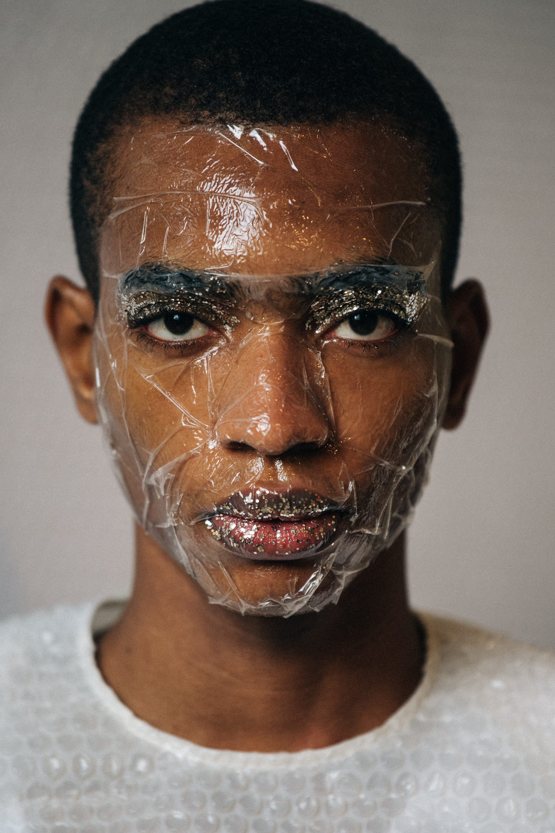 Portrait of model with sticky tape on face
