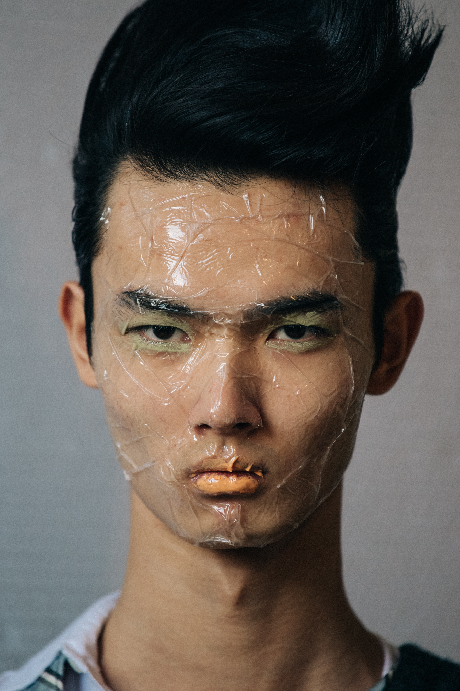 Portrait of model with sticky tape on face