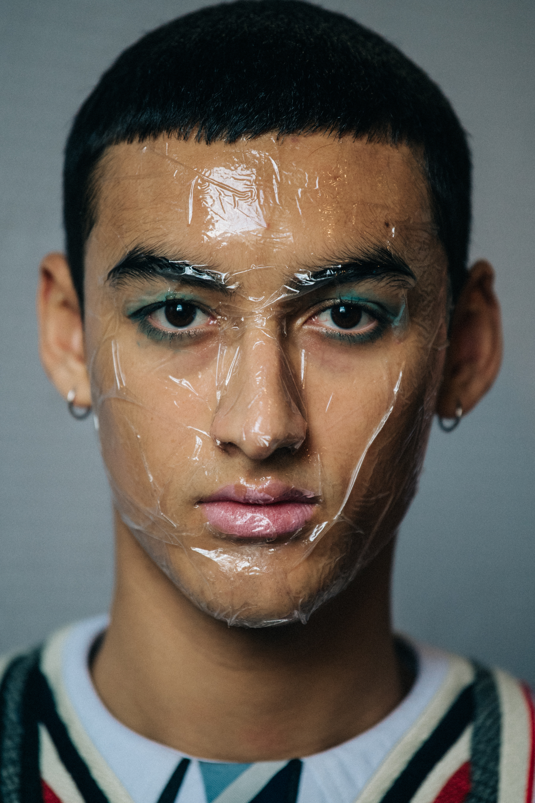 Portrait of model with sticky tape on face