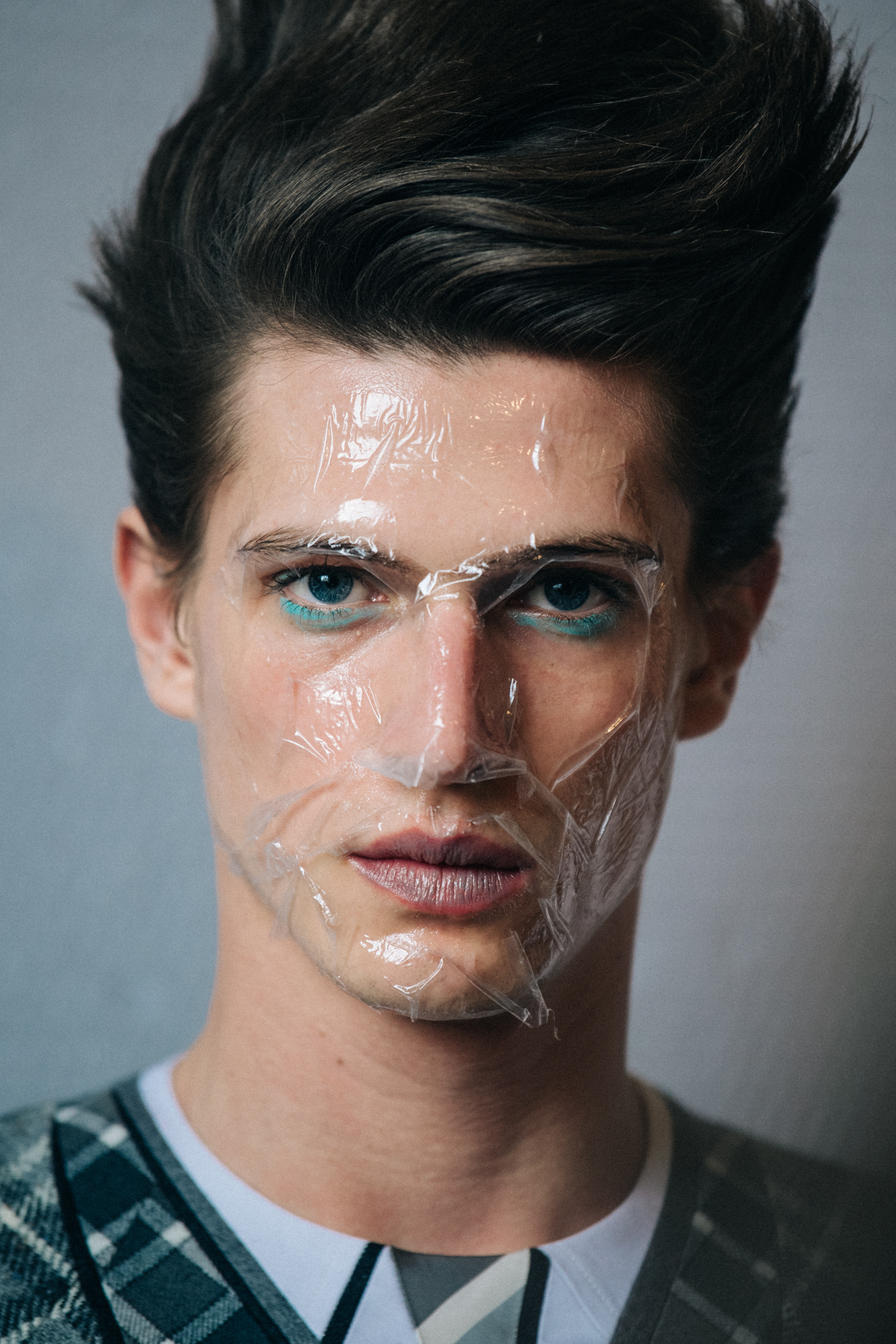 Portrait of model with sticky tape on face