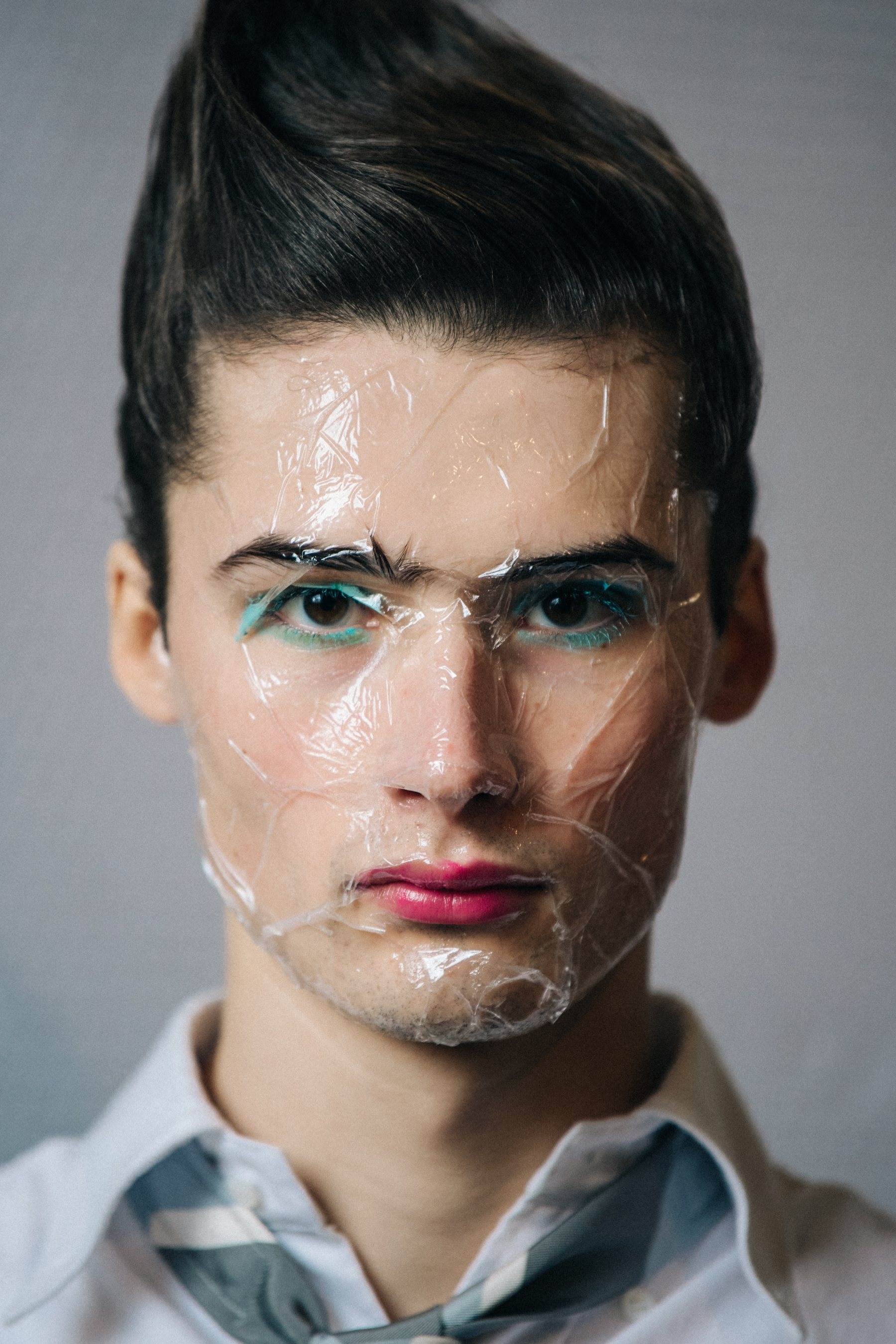 Portrait of model with sticky tape on face