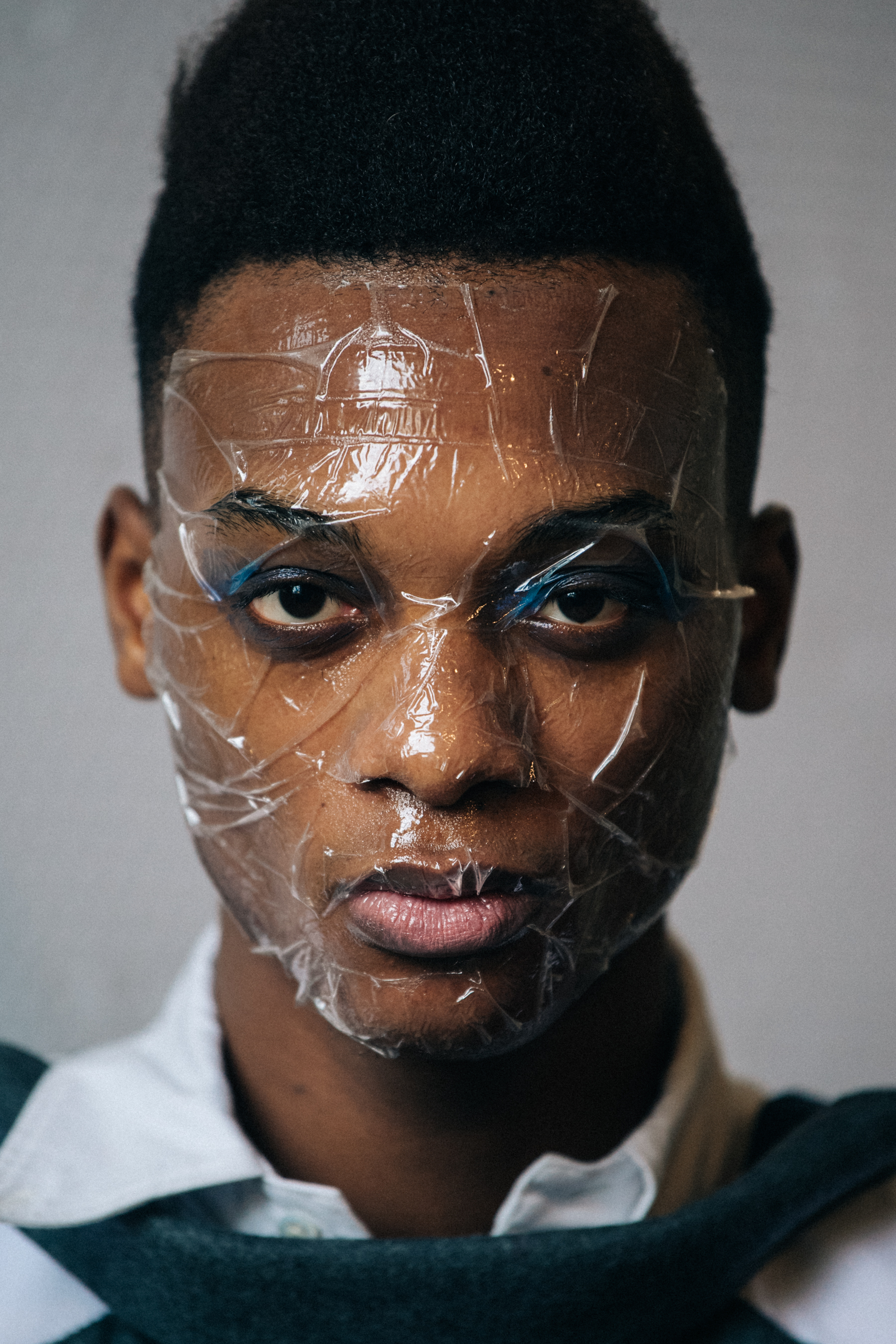 Portrait of model with sticky tape on face