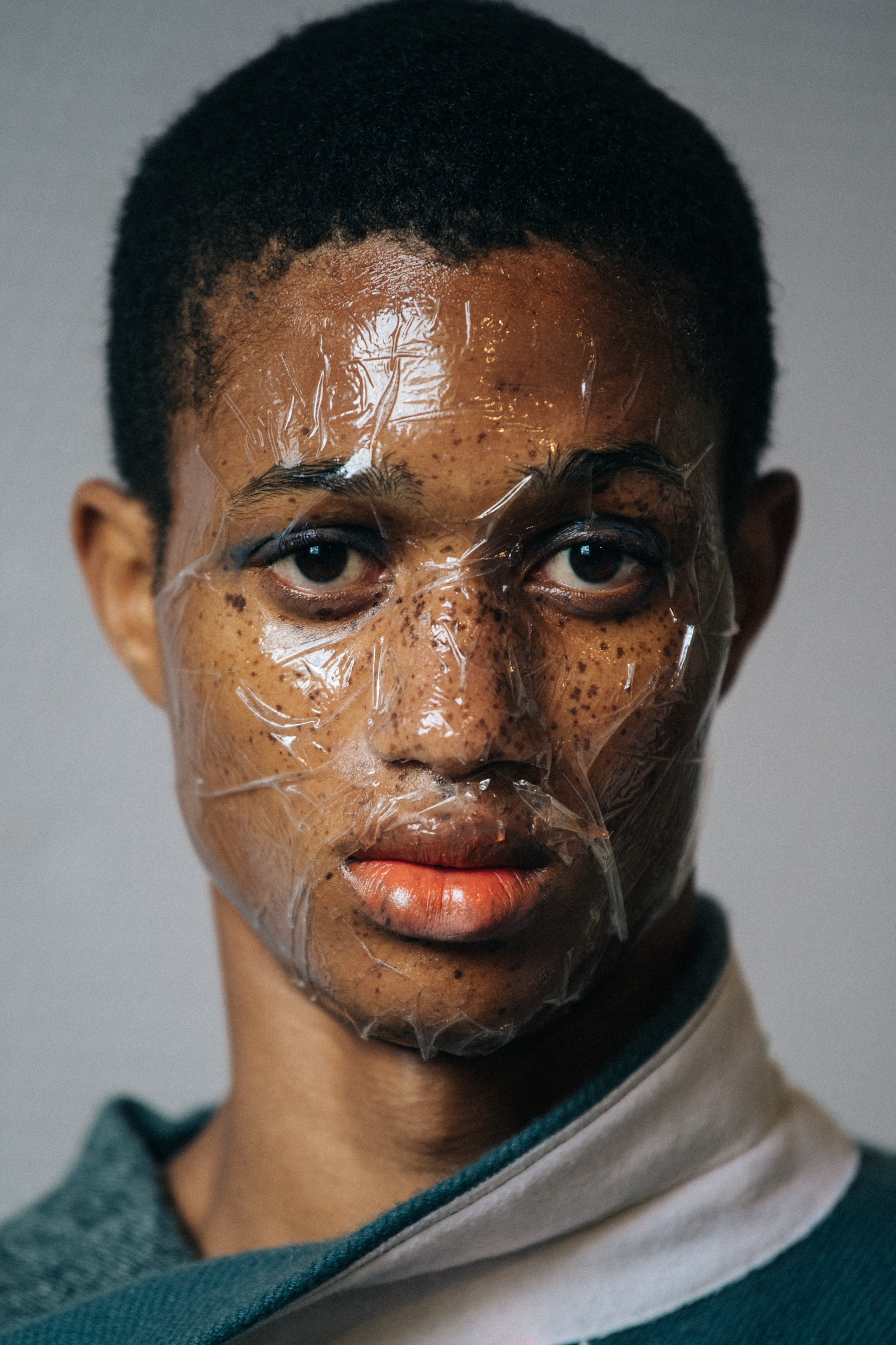 Portrait of model with sticky tape on face