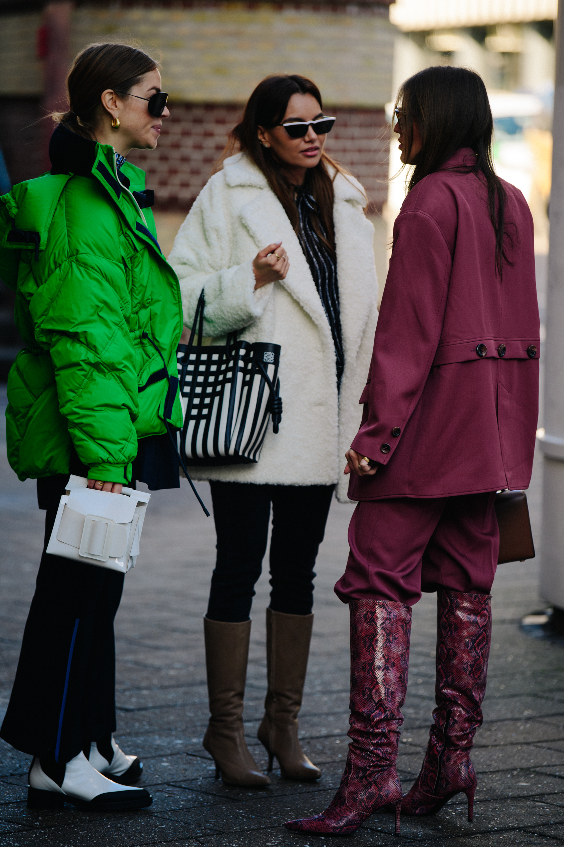 Three women wearing winter coats
