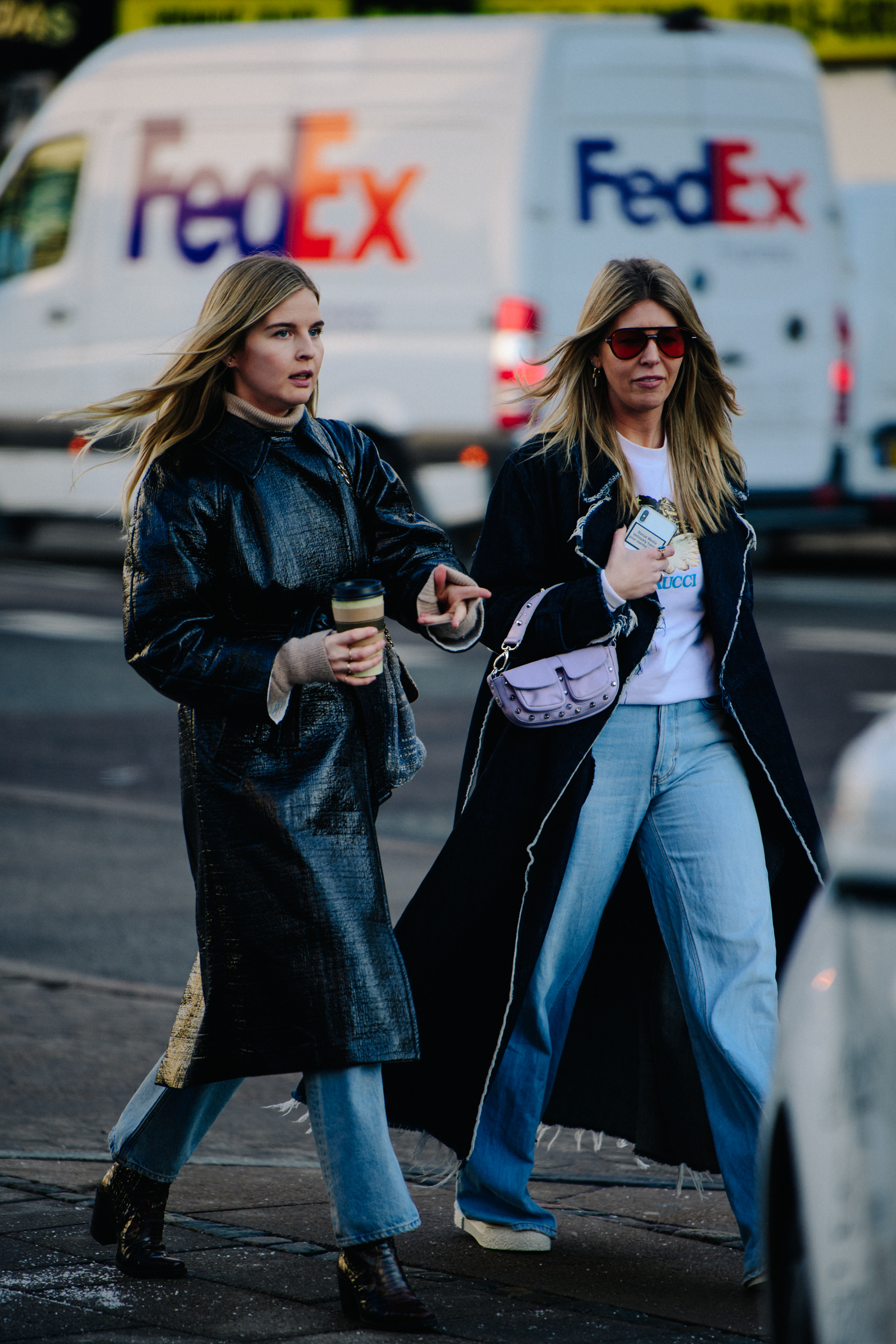 Two women wearing dark coats
