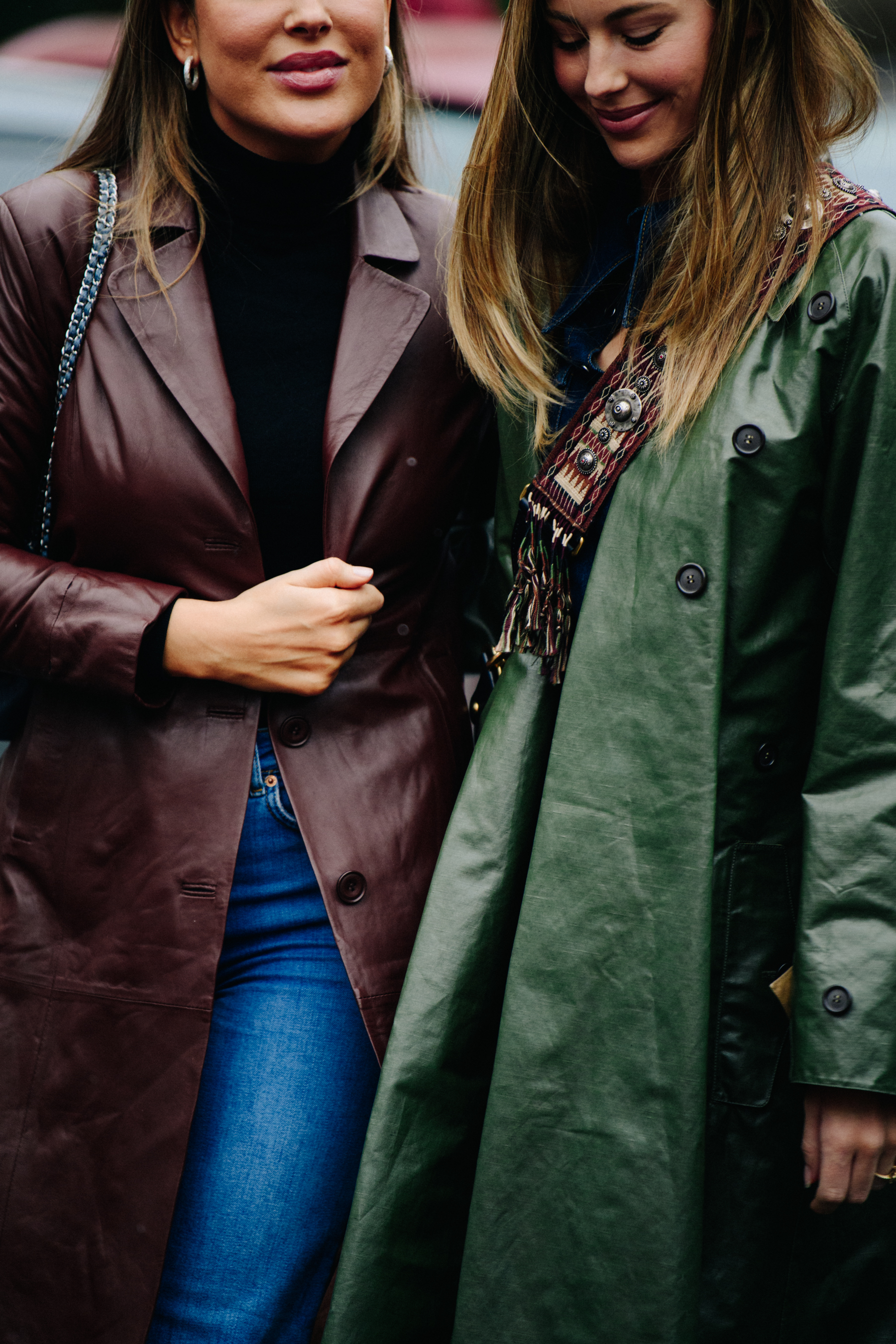 Two women wearing brown and green