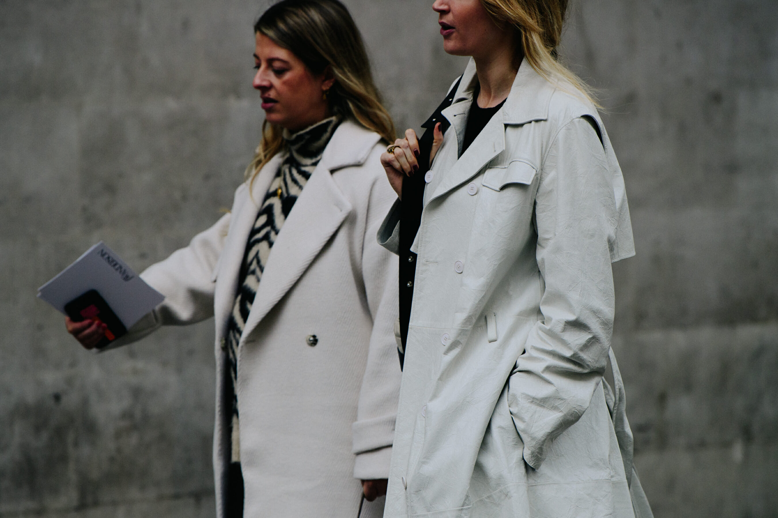 Two women wearing matching coats