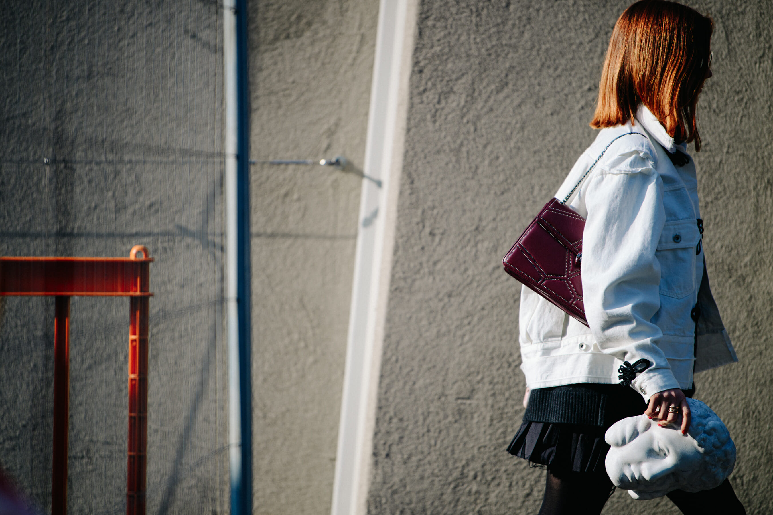 Woman wearing white denim jacket