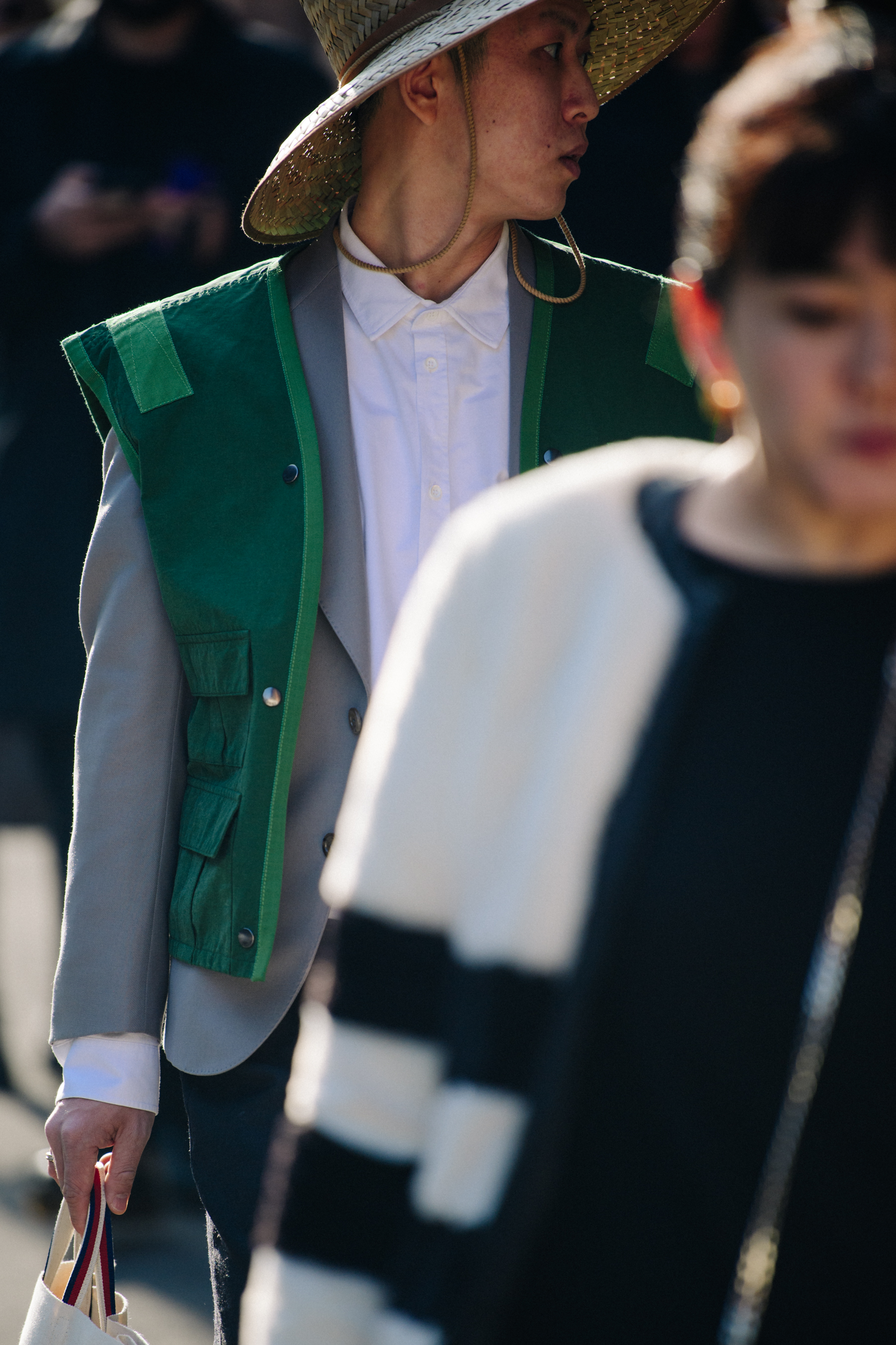 Man wearing green vest