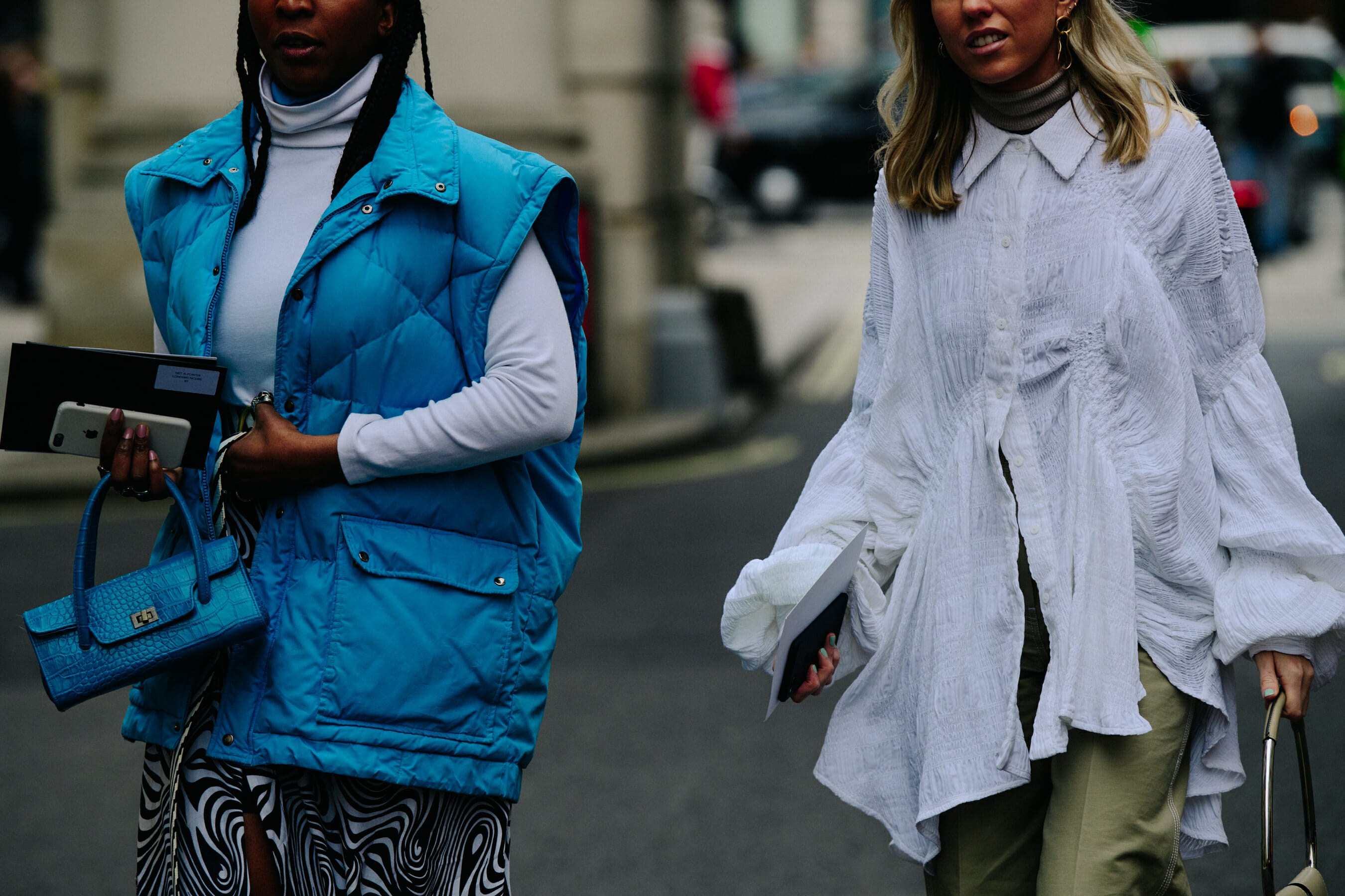 Two women wearing light clothing