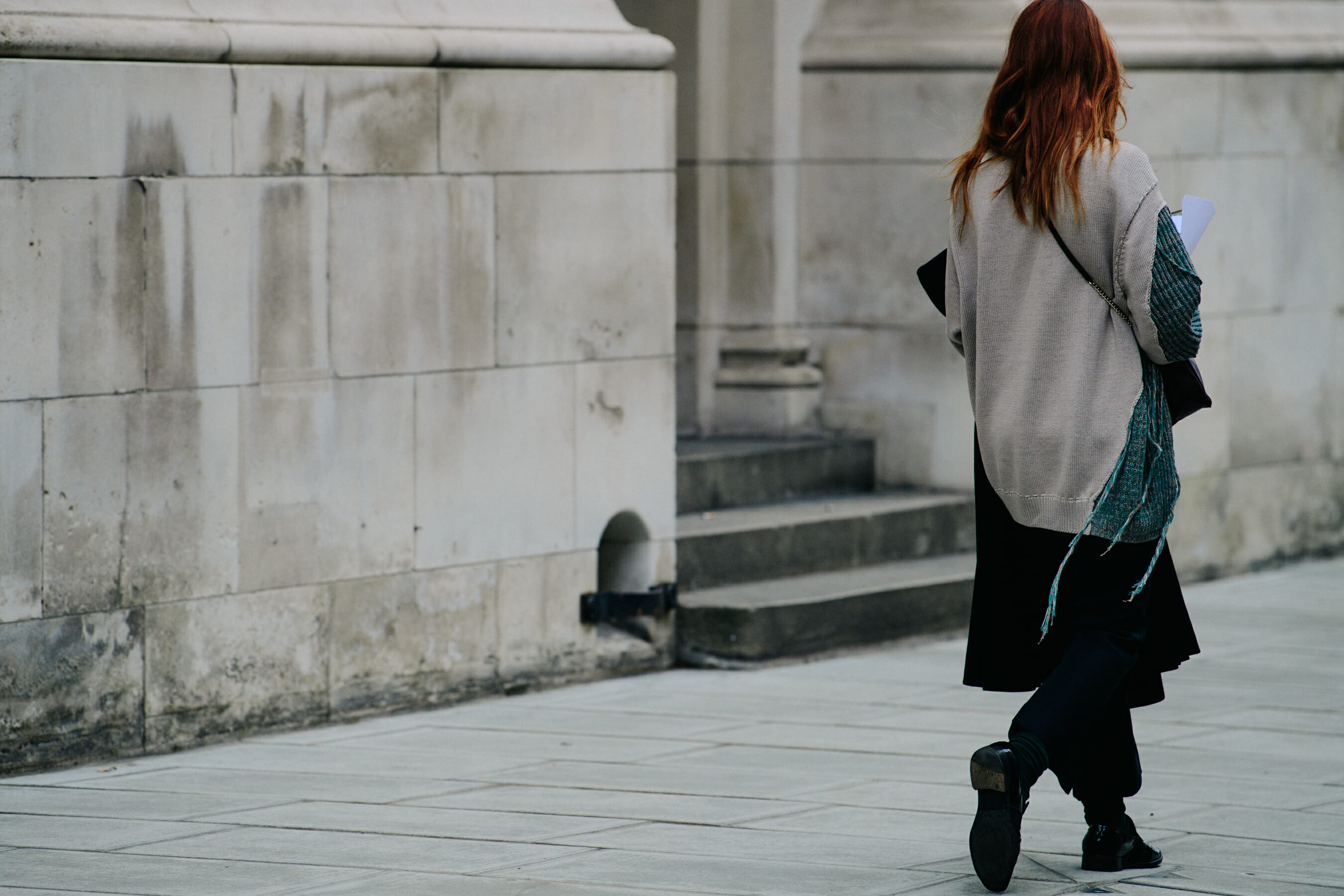 Woman wearing long grey jumper