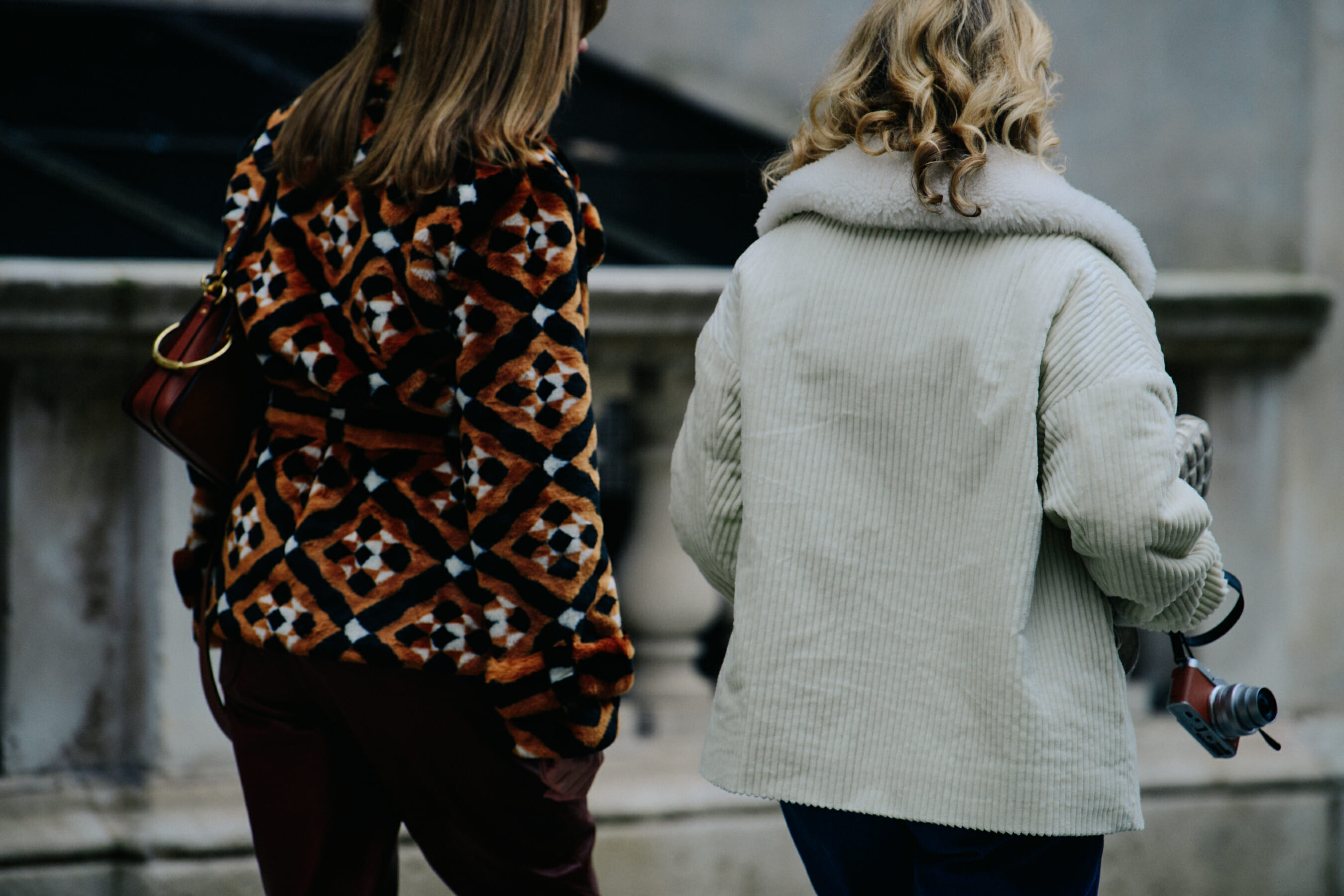 Two women wearing short jackets