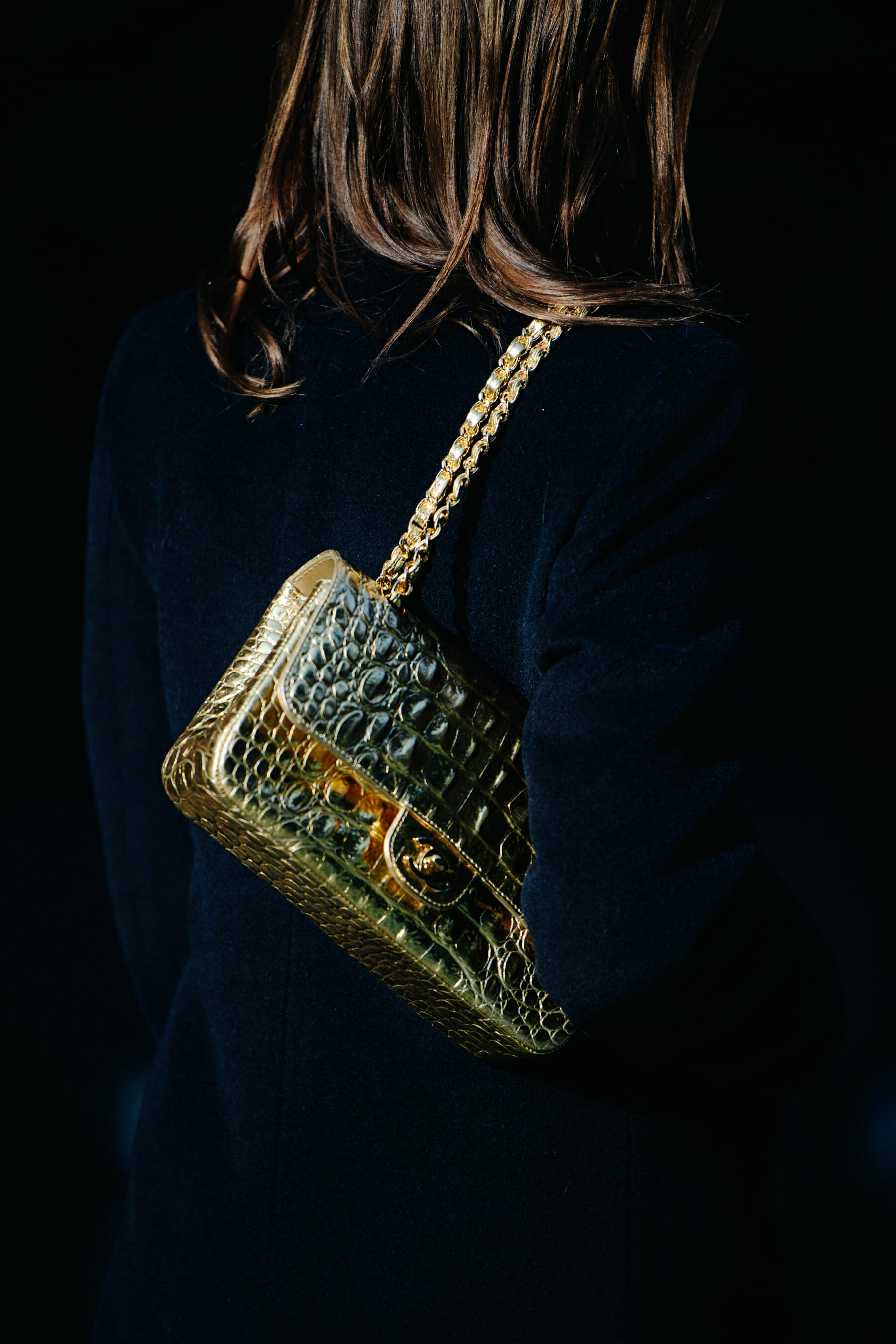 Woman carrying gold bag
