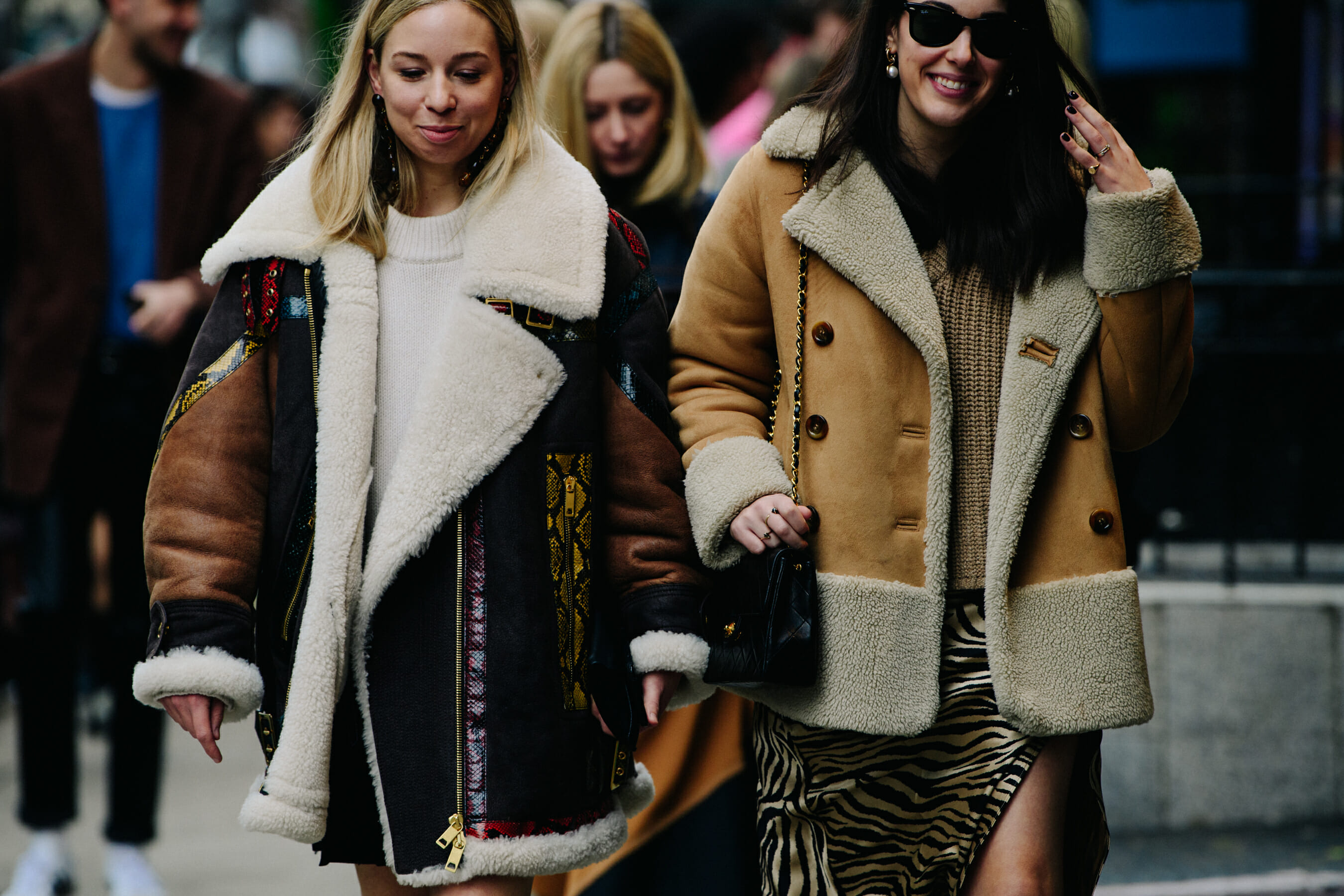 Two women wearing shearling coats