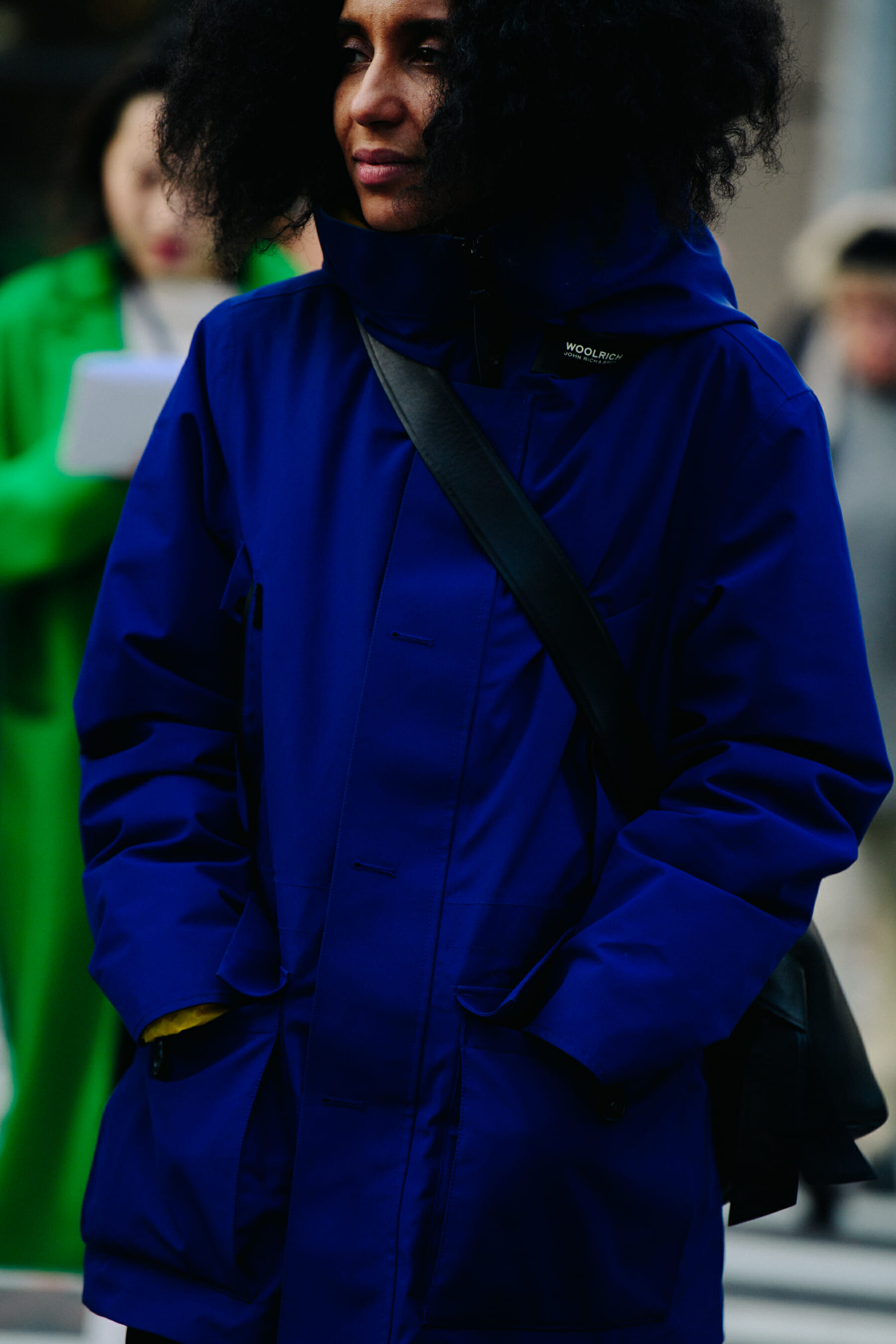 Woman wearing blue Woolrich coat