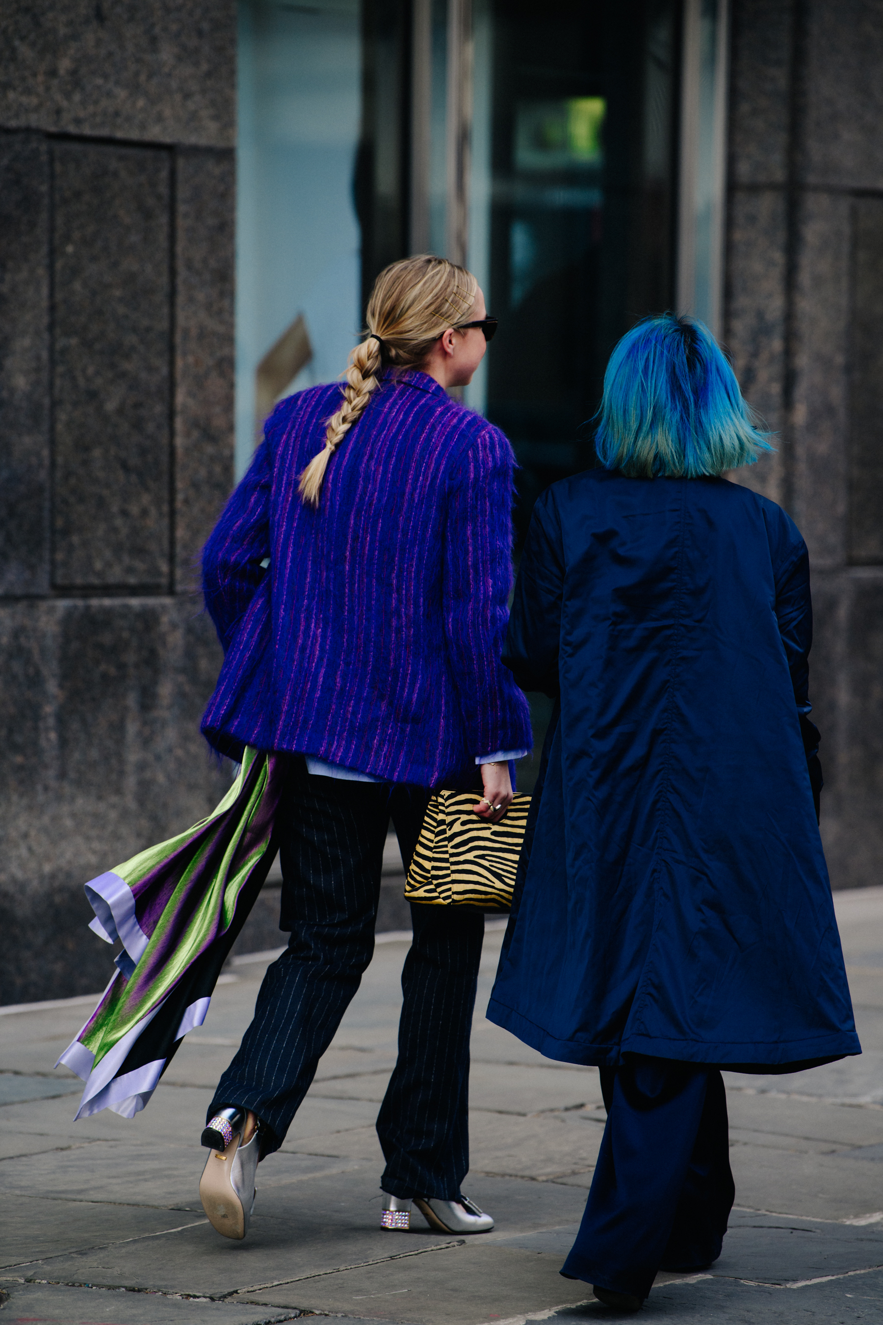Two women wearing blue