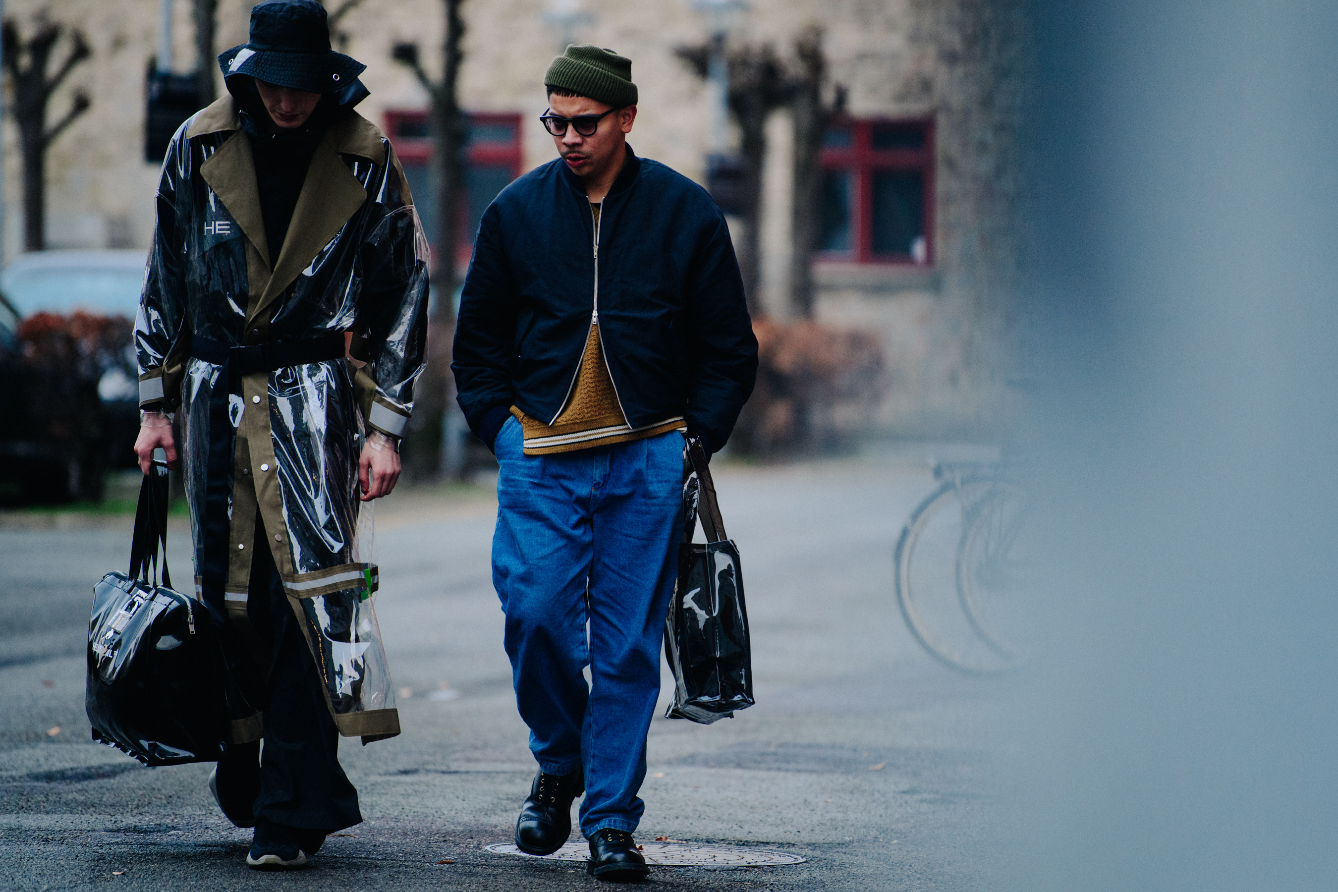 Two men wearing dark outfits