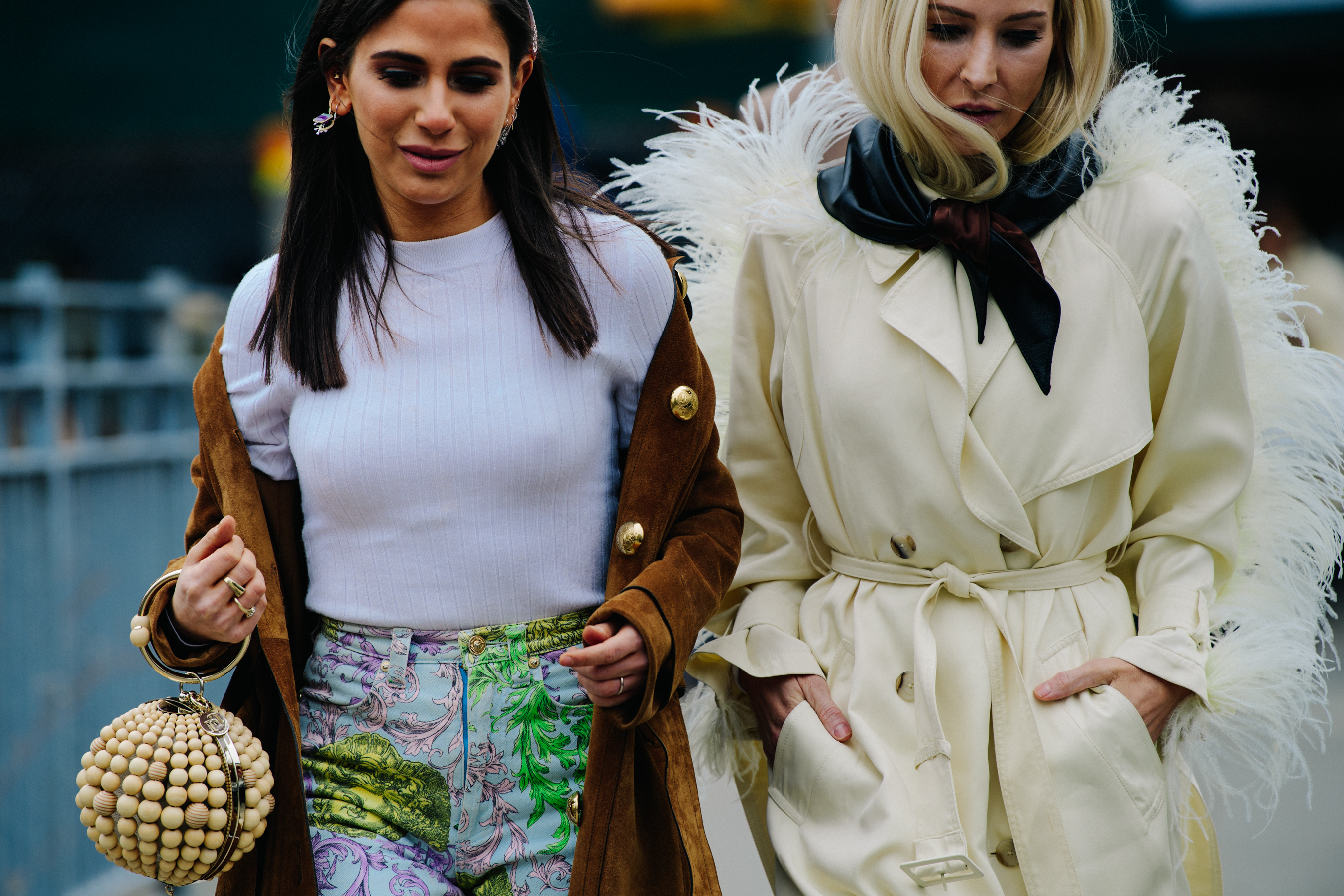 Two women wearing long coats