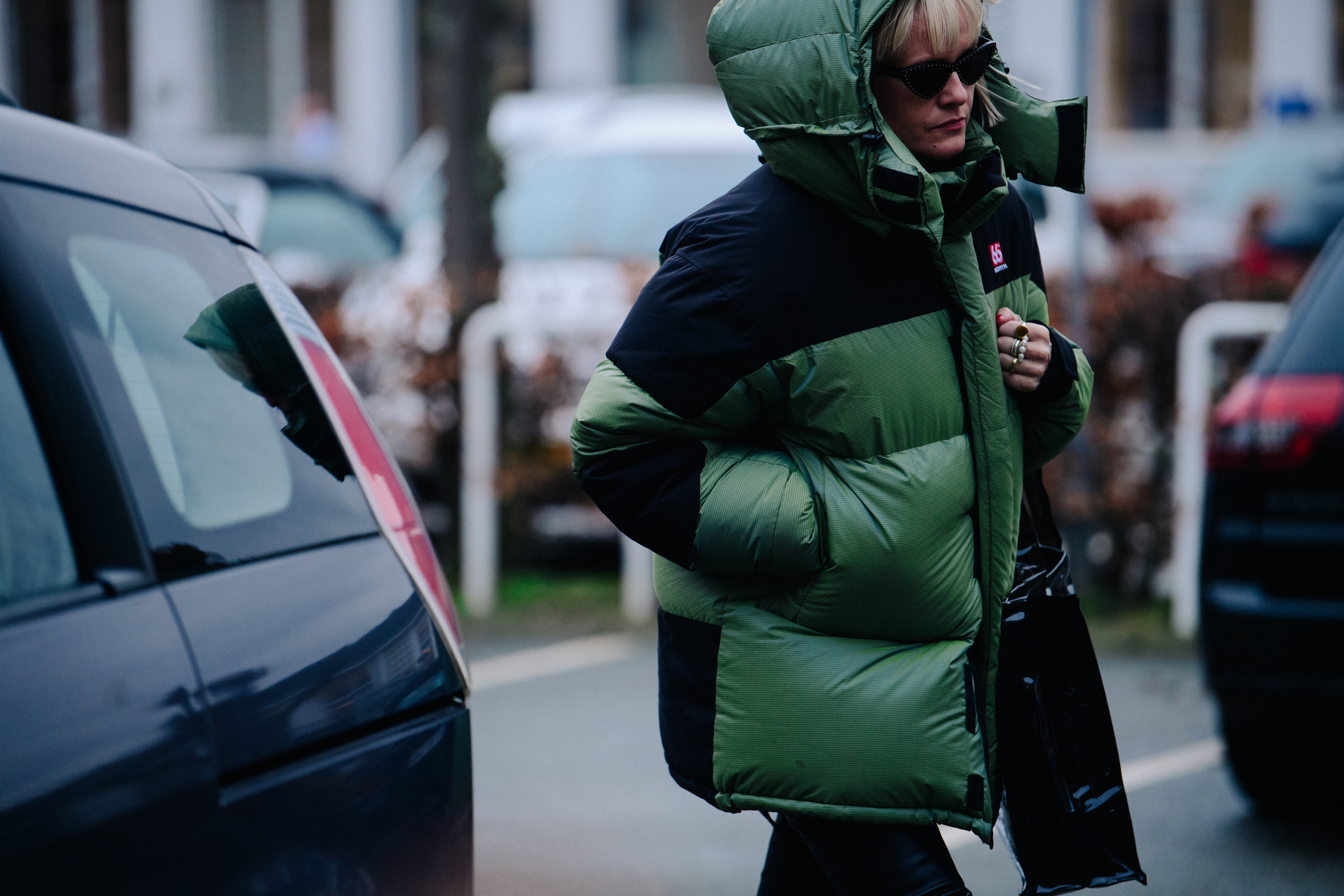 Woman wearing green 66North coat