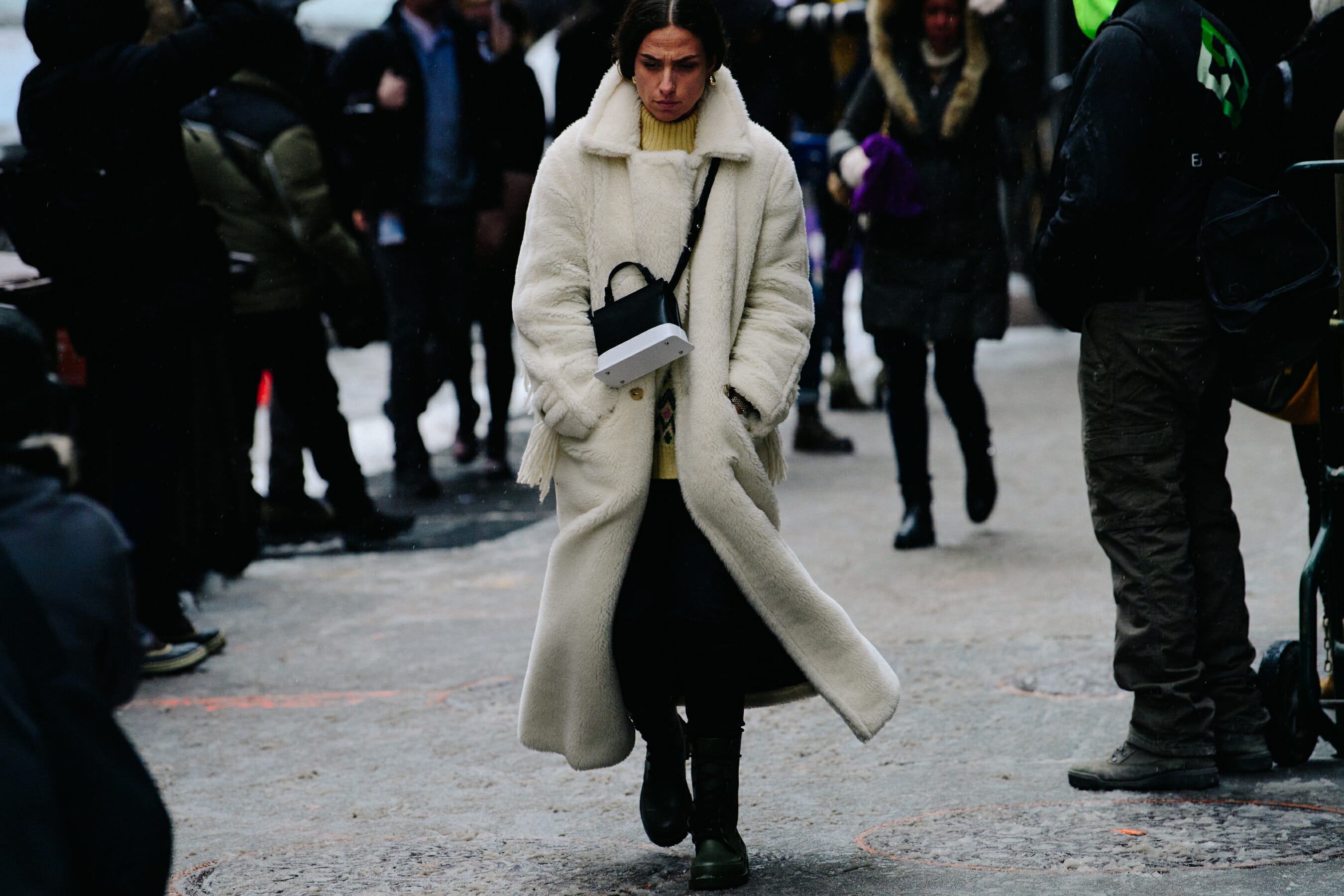 Woman wearing white fur coat